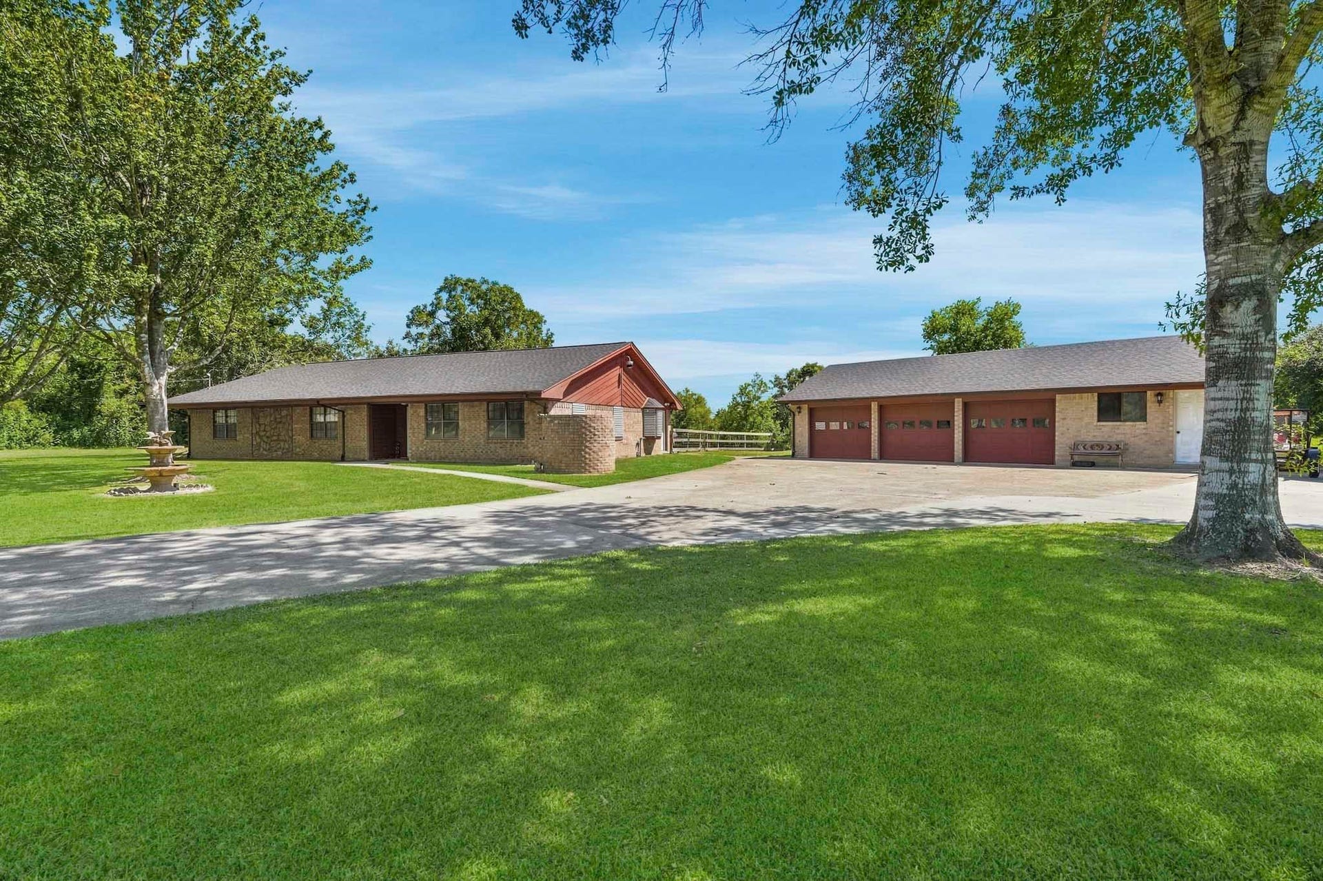 16101 Bluebird Street, Santa Fe, TX 77517 Charming ranch-style home with a spacious front yard, mature trees, and a large three-car garage, perfect for accommodating multiple vehicles or extra storage.
