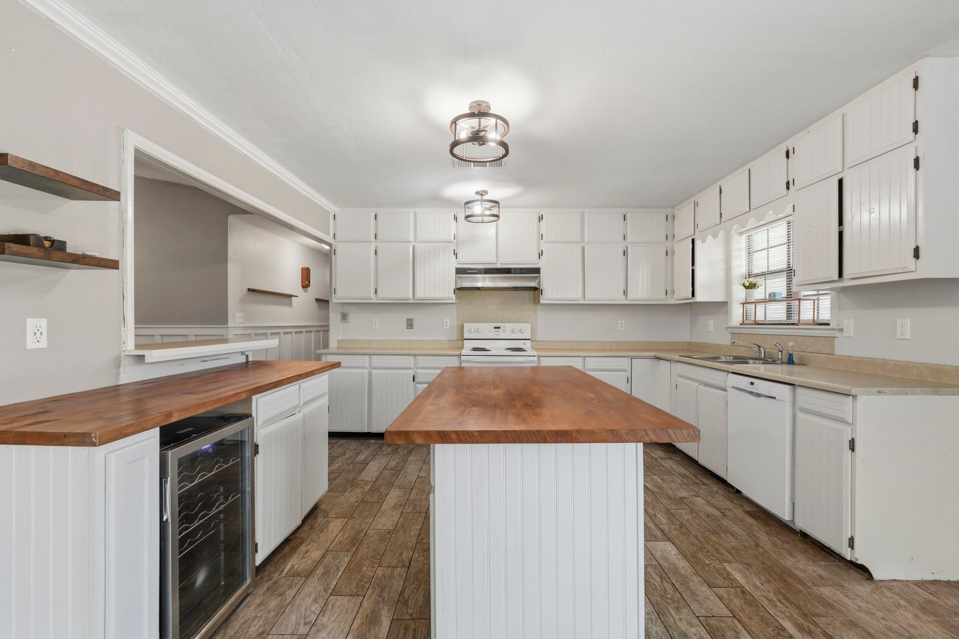 16101 Bluebird Street, Santa Fe, TX 77517 Spacious kitchen with white cabinetry and upgraded lighting, featuring a central island.
