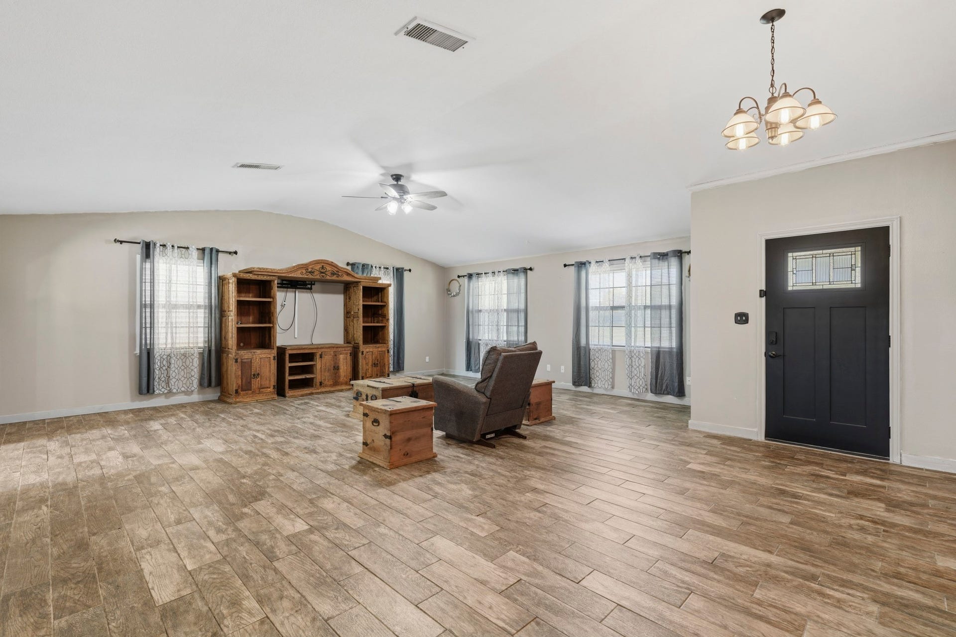16101 Bluebird Street, Santa Fe, TX 77517 Abundant natural light, and a ceiling fan, perfect for relaxation or entertainment.