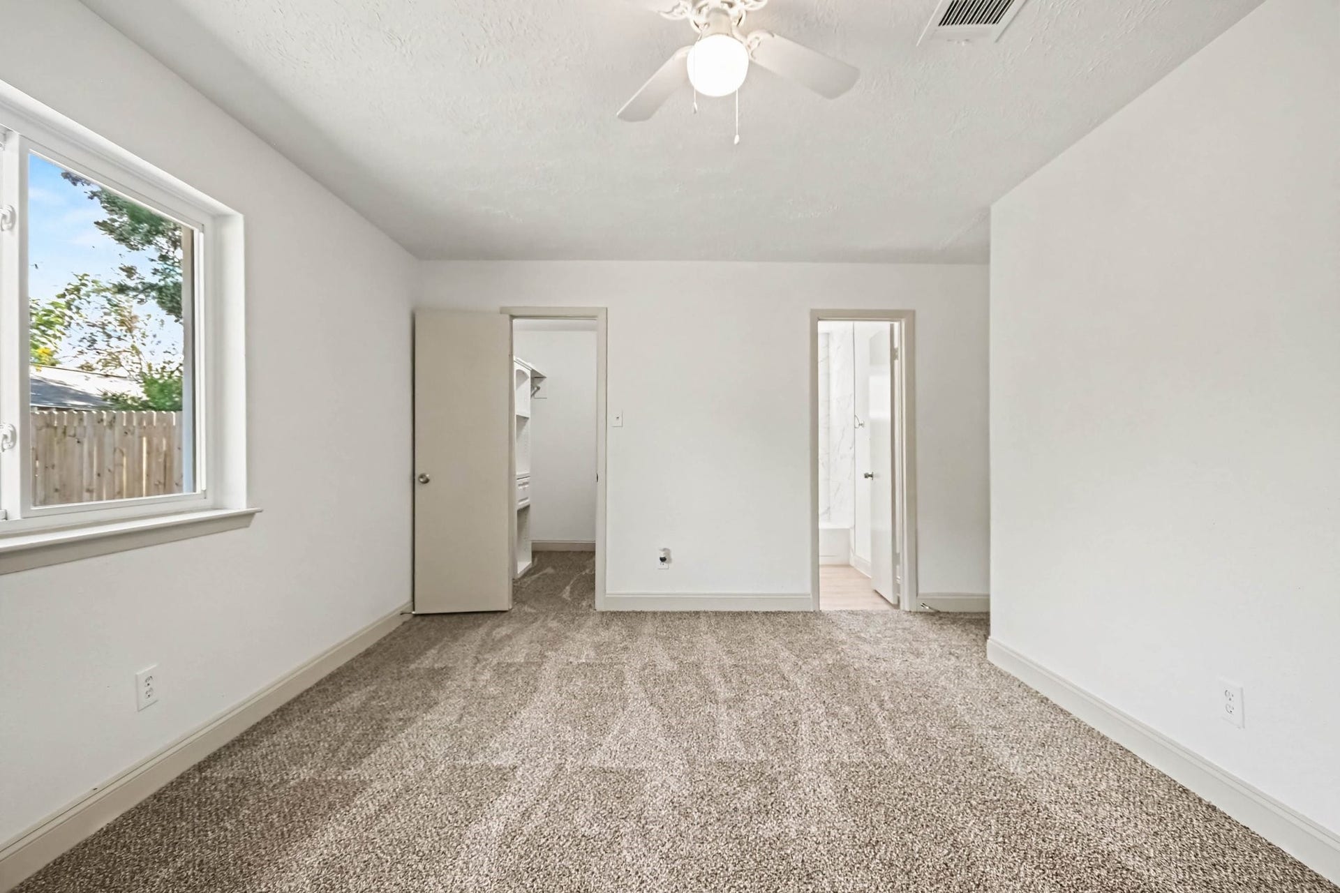 4010 Bluebonnet Trail, Deer Park, TX 77536 Spacious bedroom with ensuite bathroom on the right and walk in closet on the left.