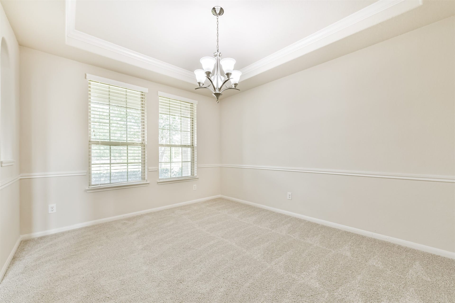 2811 Afton Drive, Pearland, TX 77581 Elegant formal dining room featuring abundant natural light and sophisticated crown molding, perfect for hosting memorable gatherings.