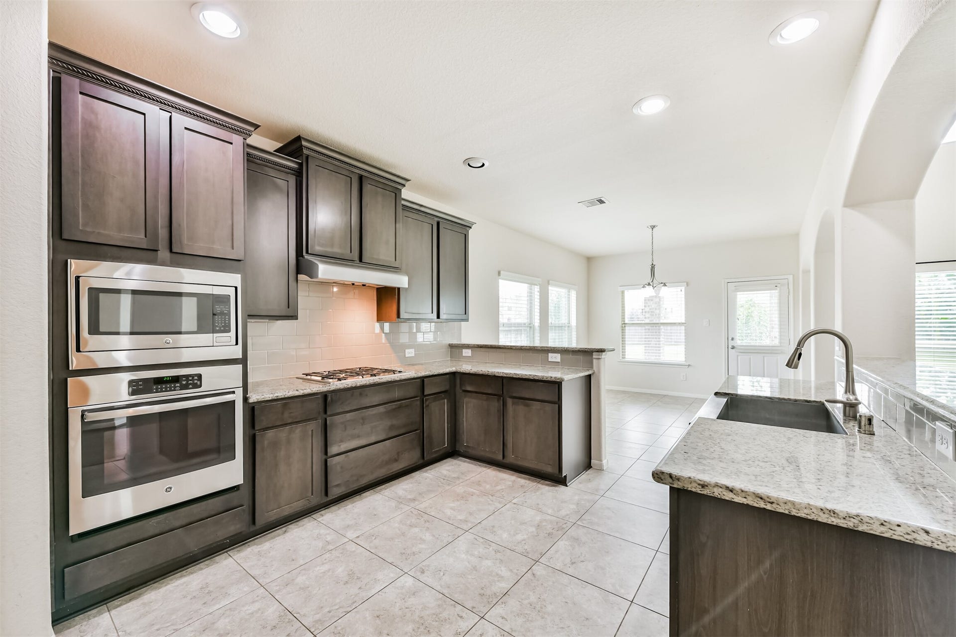2811 Afton Drive, Pearland, TX 77581 This modern kitchen features sleek granite countertops, stainless steel appliances, and elegant cabinetry. With its open layout and abundant natural light, it's perfect for cooking and entertaining.