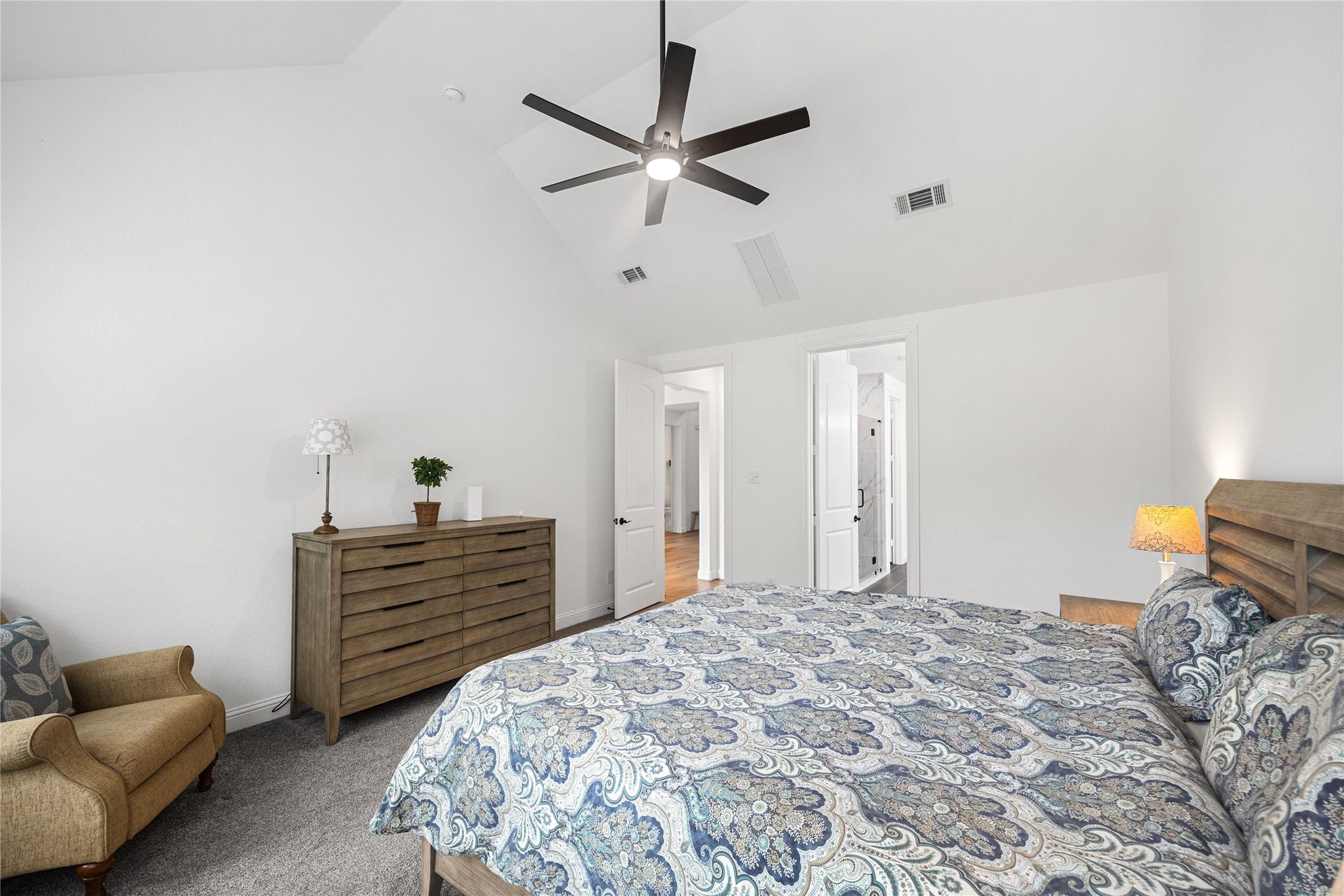 Primary bedroom with high ceilings and ensuite bathroom.