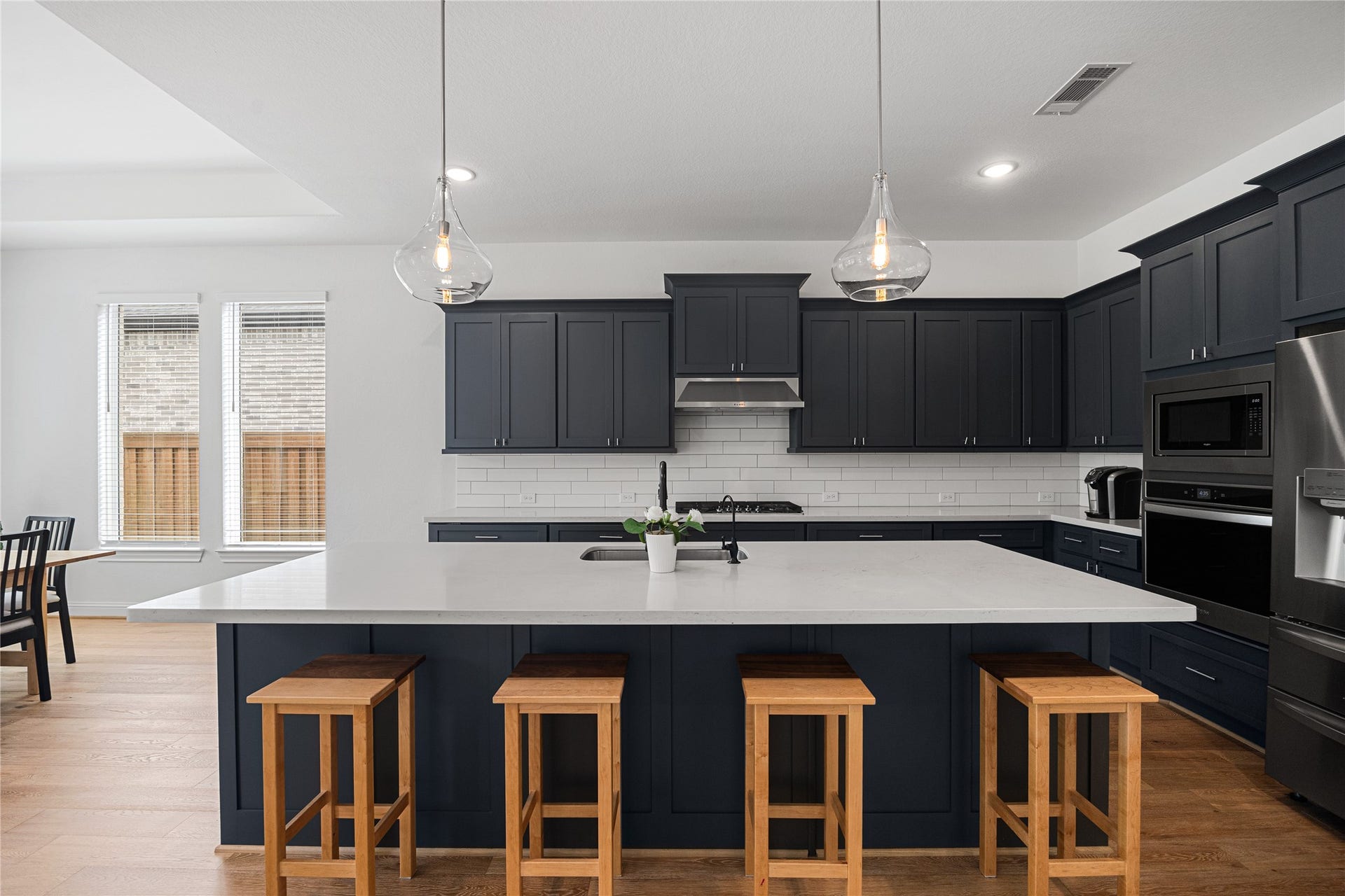 Chef's Kitchen with shaker-style cabinets hardware and an oversized island.