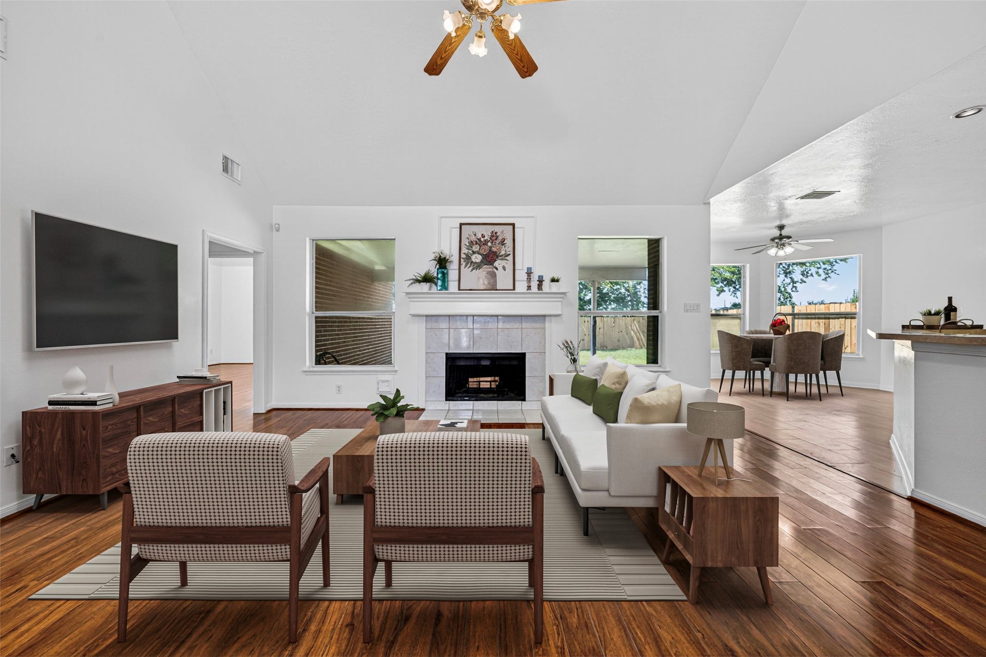 13910 Sunset View Drive, Houston, TX 77083 The living room serves as the heart of the home, featuring a stunning fireplace and an open-concept layout that overlooks the kitchen