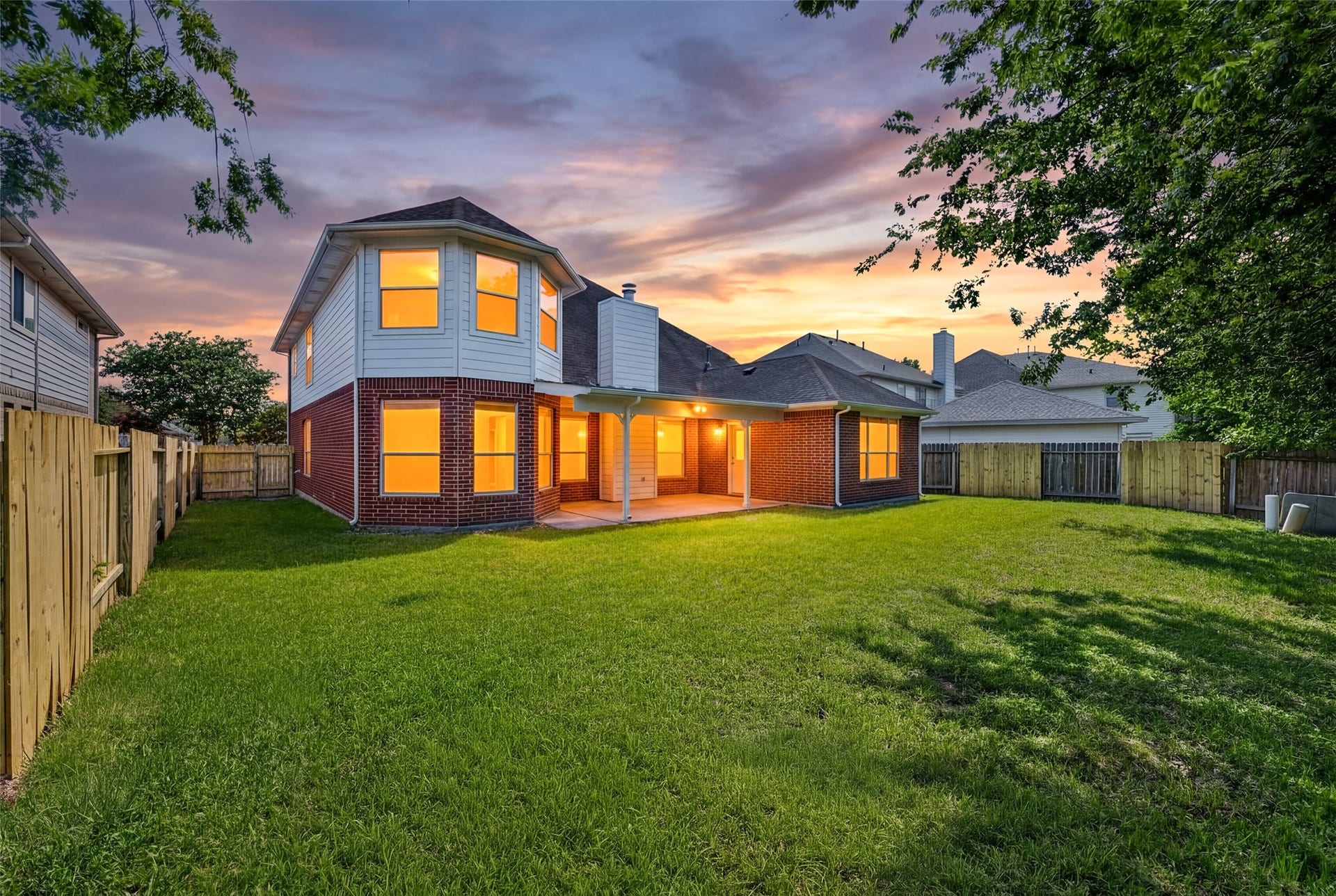 13910 Sunset View Drive, Houston, TX 77083 The backyard serves as a private oasis, filled with mature trees that provide refreshing shade for outdoor relaxation.