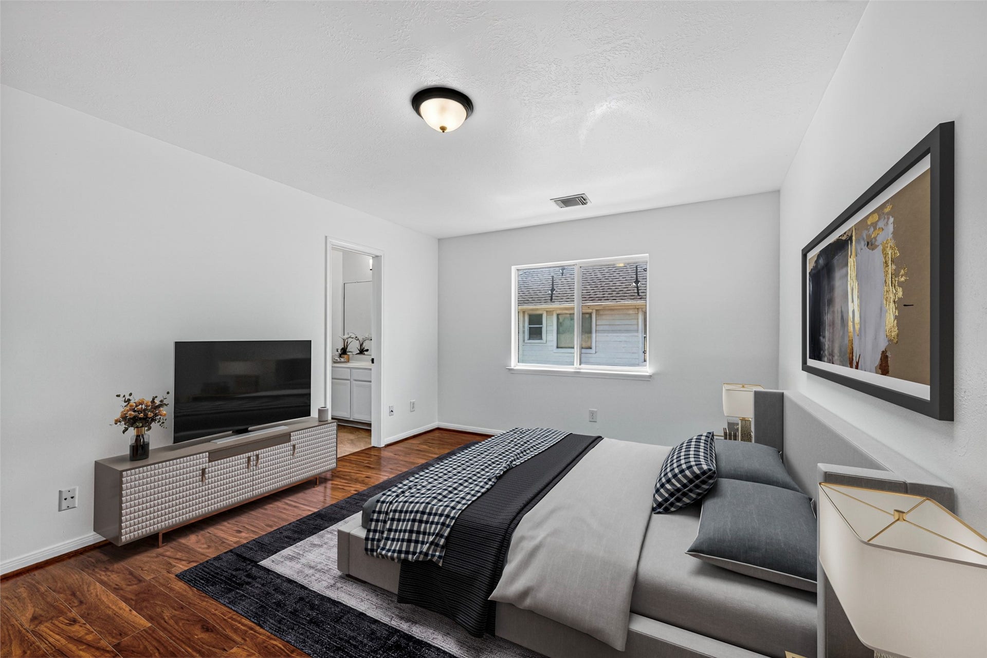 13910 Sunset View Drive, Houston, TX 77083 This quiet fifth bedroom serves as a versatile sanctuary, featuring warm wood flooring and a view that captures the gentle light of the day.