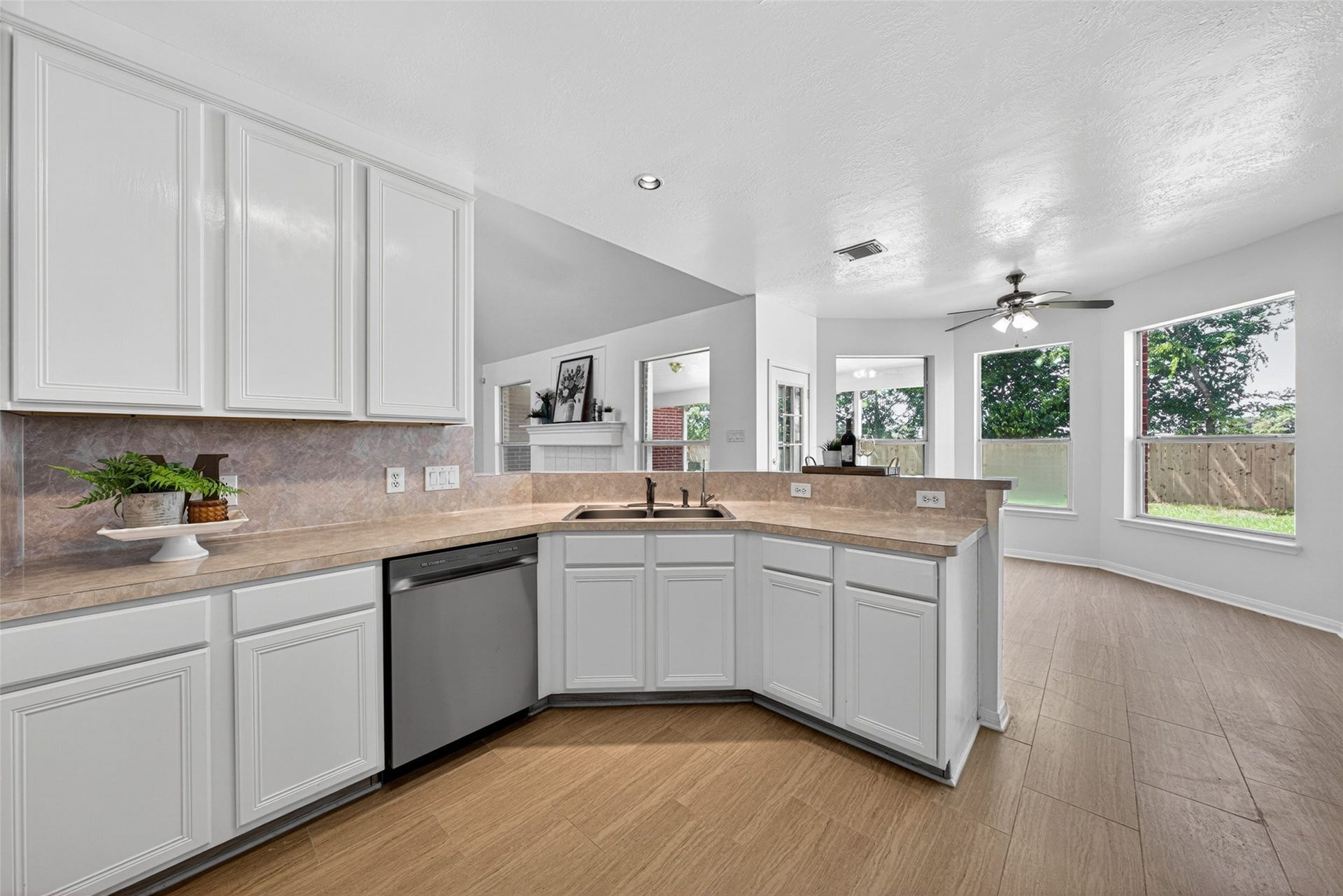 13910 Sunset View Drive, Houston, TX 77083 Overlooking the breakfast area and living area, this open-concept kitchen ensures you never miss a moment while preparing meals or entertaining guests.