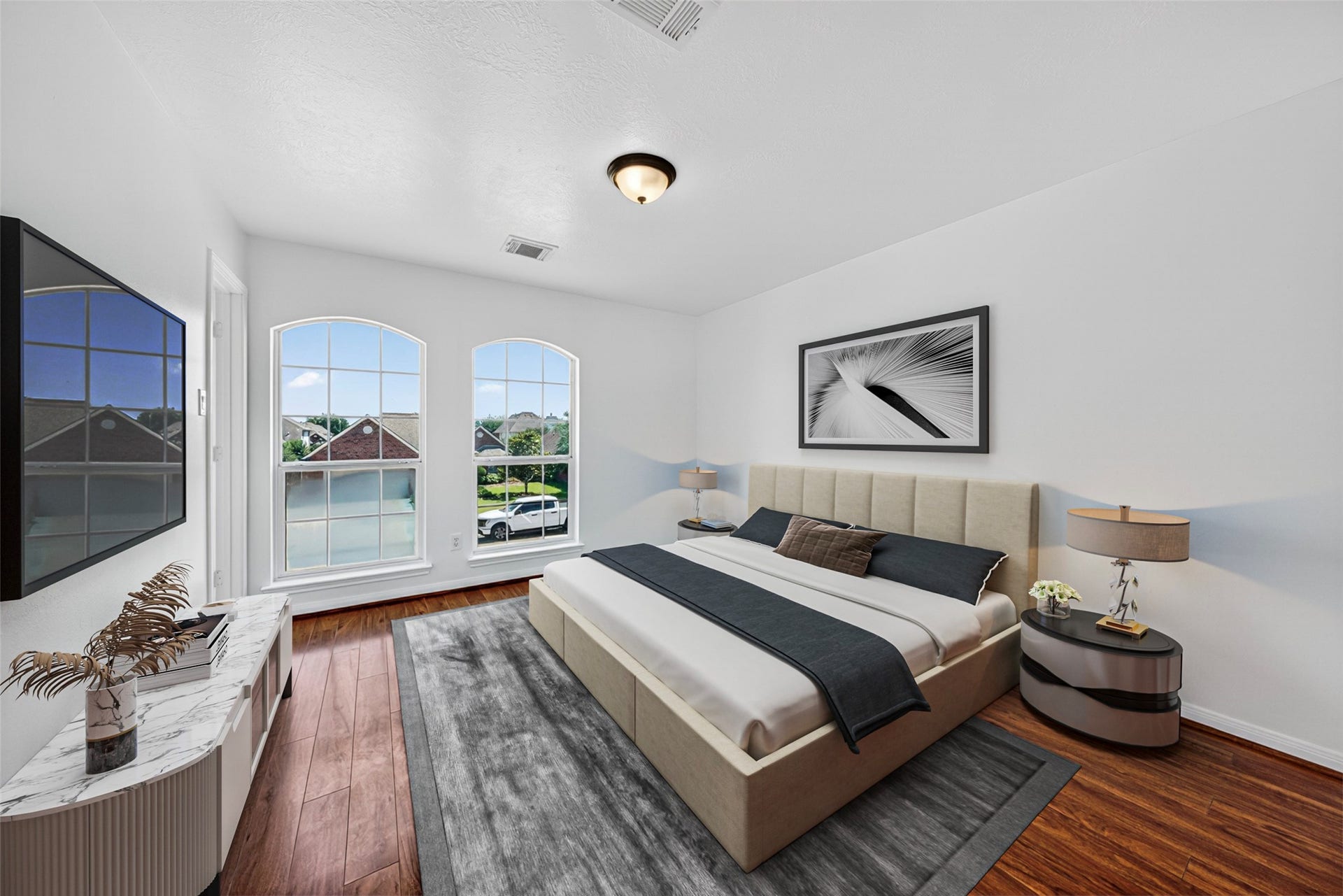 13910 Sunset View Drive, Houston, TX 77083 This serene fourth bedroom offers a bright and refreshing atmosphere, highlighted by elegant arched windows that fill the space with abundant natural light.