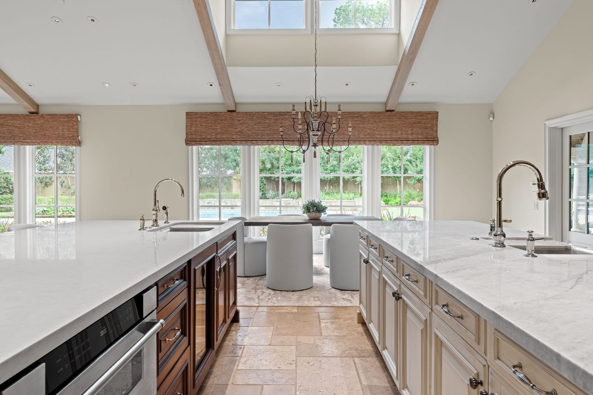 1 Gage Court, Houston, TX 77024 A long run of windows brings natural light across the kitchens main sink and newly installed Taj Mahal countertops. The generous workspace is designed to keep preparation areas open while maintaining views toward the grounds.