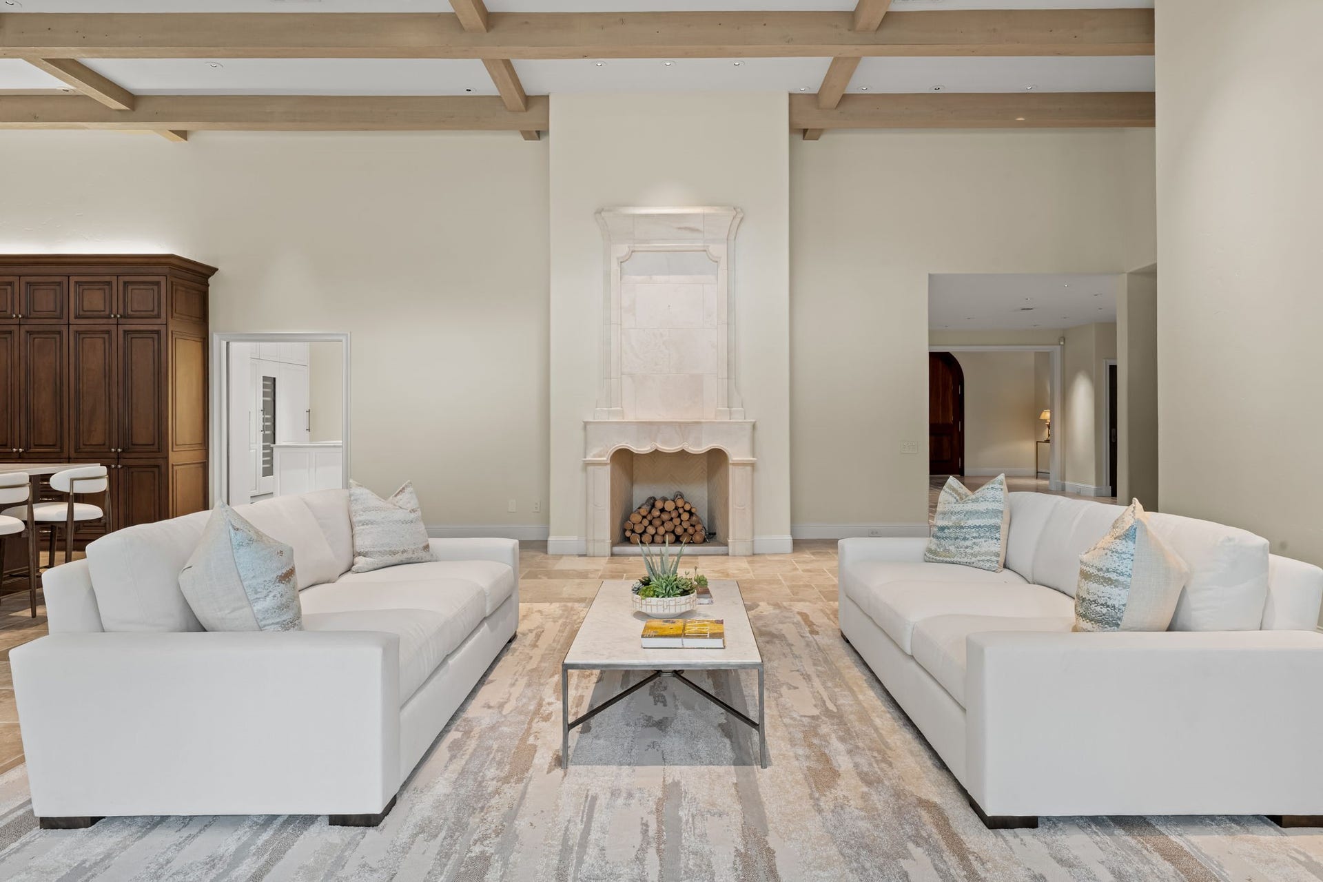 1 Gage Court, Houston, TX 77024 The great room is a true showpiece, anchored by a dramatic stone fireplace beneath soaring ceilings and exposed wood beams. According to the seller, select marble used throughout the home was sourced in Italy from the same quarry associated with Michelangelo, adding a remarkable sense of history and provenance to the residence.