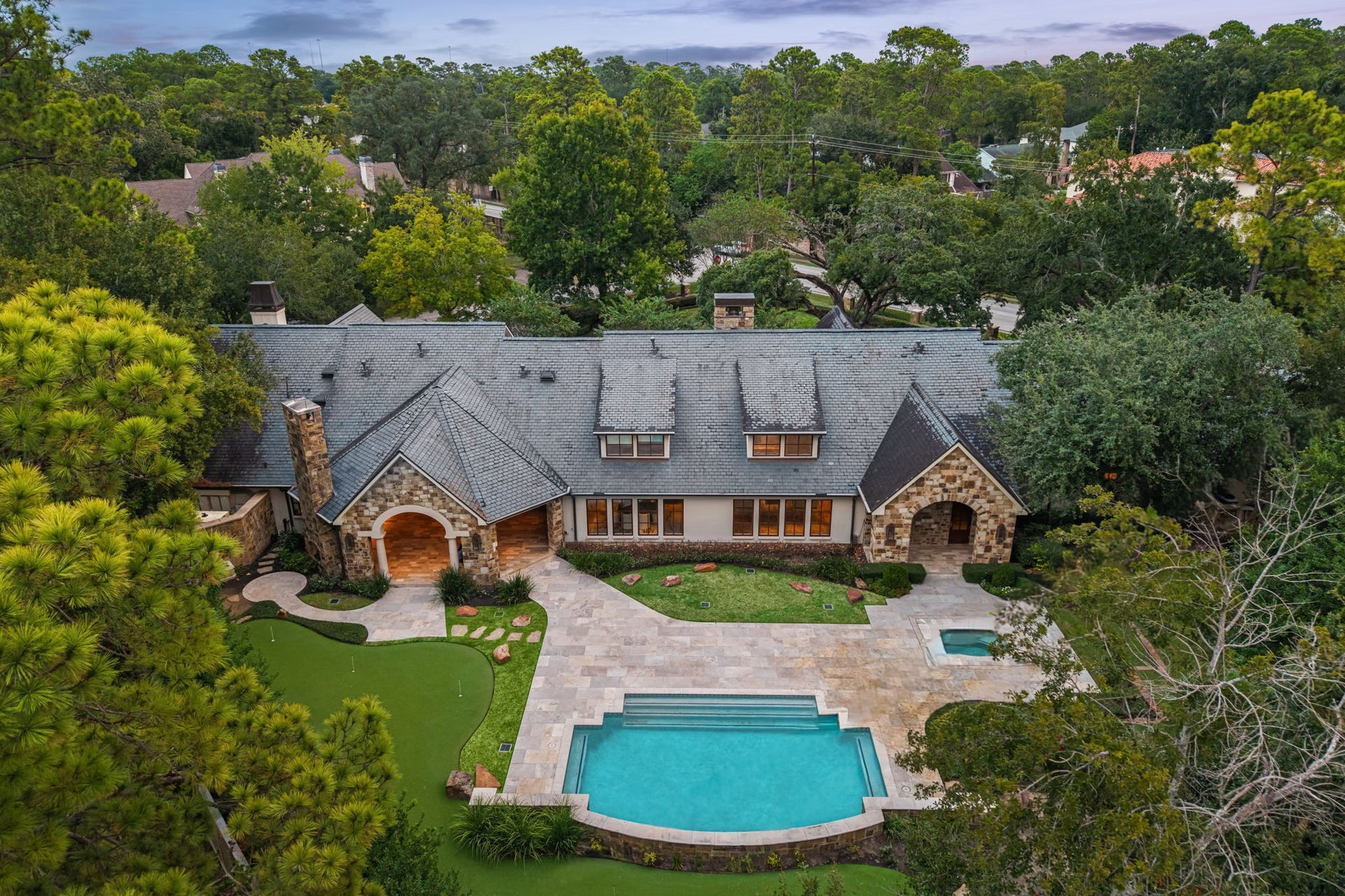 1 Gage Court, Houston, TX 77024 Aerial view of 1 Gage Court, a custom 2005 residence designed by J. Marshall Porterfield, Jr., set on 37,824 square feet in Bunker Hill Gardens. The fully gated estate brings together predominantly single-story living, mature grounds and resort-style outdoor spaces.