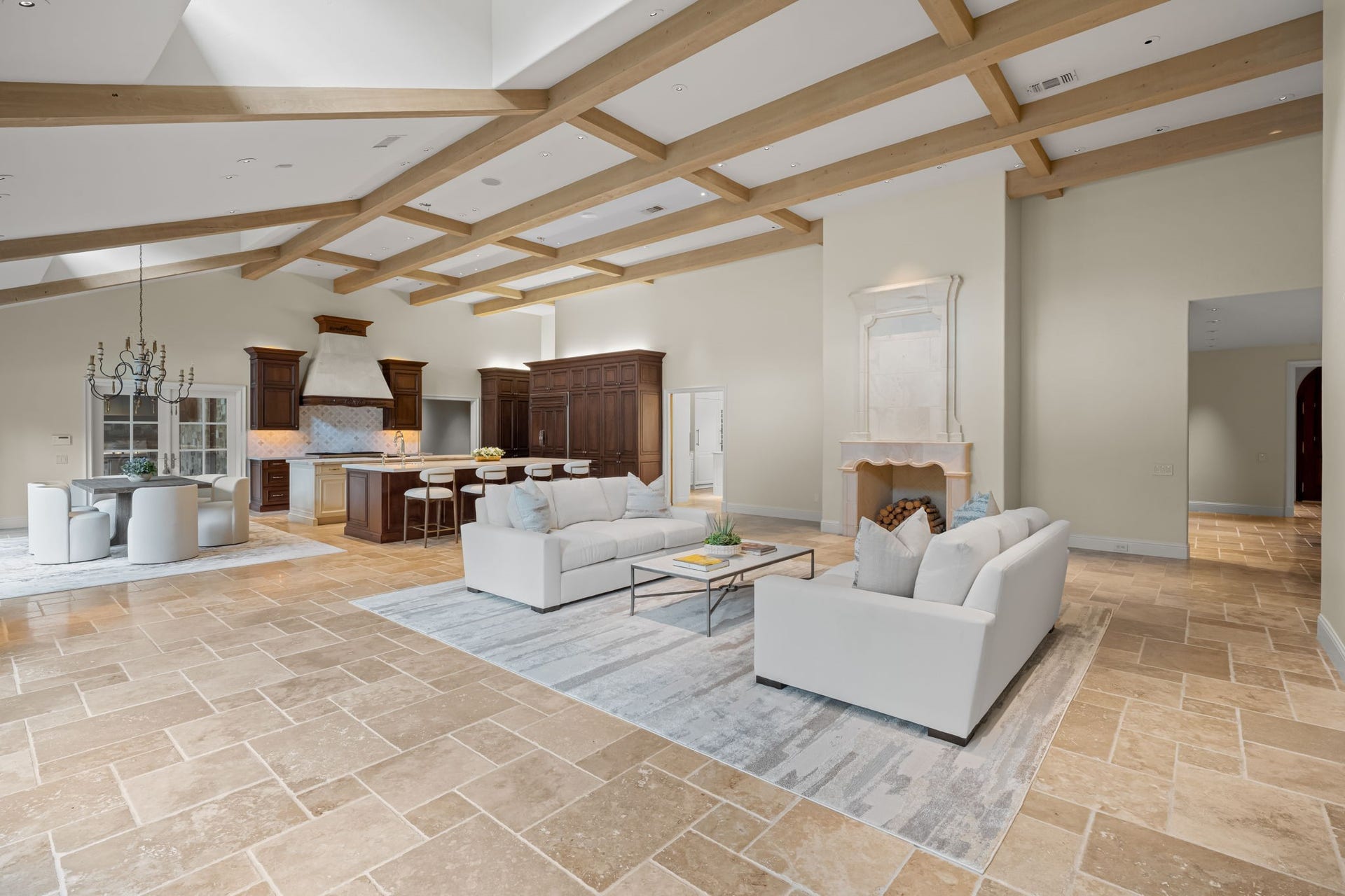 1 Gage Court, Houston, TX 77024 A substantial marble fireplace anchors the great room and adds architectural weight to the space. Exposed wood beams, travertine flooring and the open connection to the kitchen create a strong sense of continuity throughout the main living area.