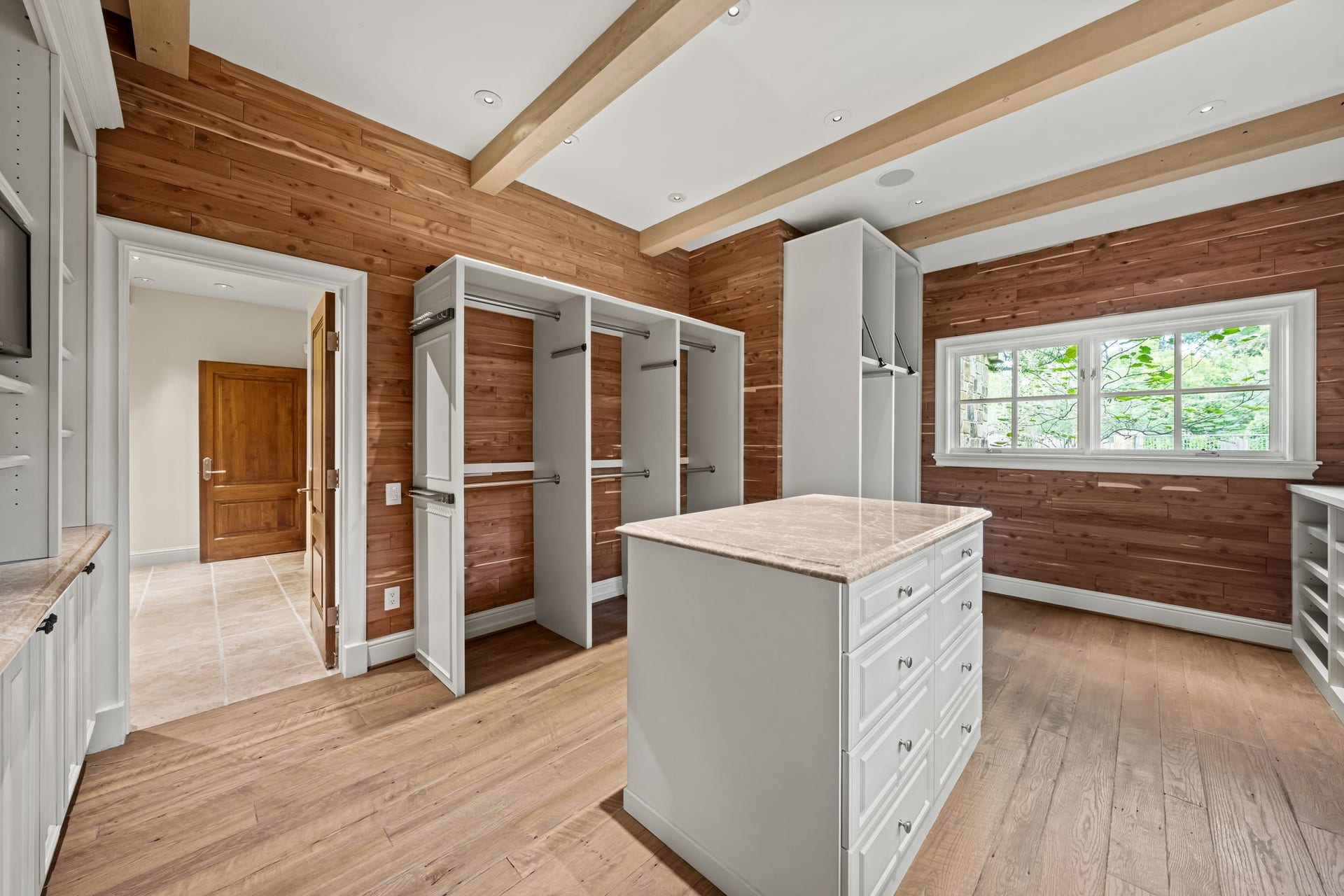 1 Gage Court, Houston, TX 77024 Originally designed as a secondary bedroom, this space was converted into an additional cedar-lined wardrobe and dressing room with built-in storage and a center island. It has direct access from the primary bath and could be converted back into a bedroom if desired.