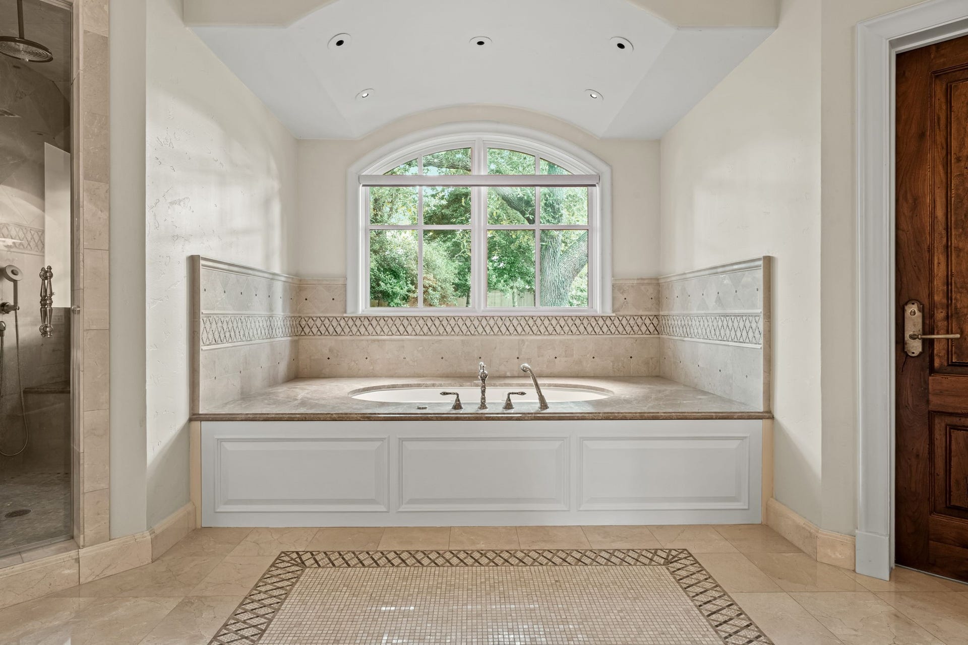1 Gage Court, Houston, TX 77024 The primary bath also has heated marble flooring, a jetted soaking tub and a large arched window overlooking the landscaped grounds. Marble surfaces and detailed millwork continue the homes traditional architectural character.