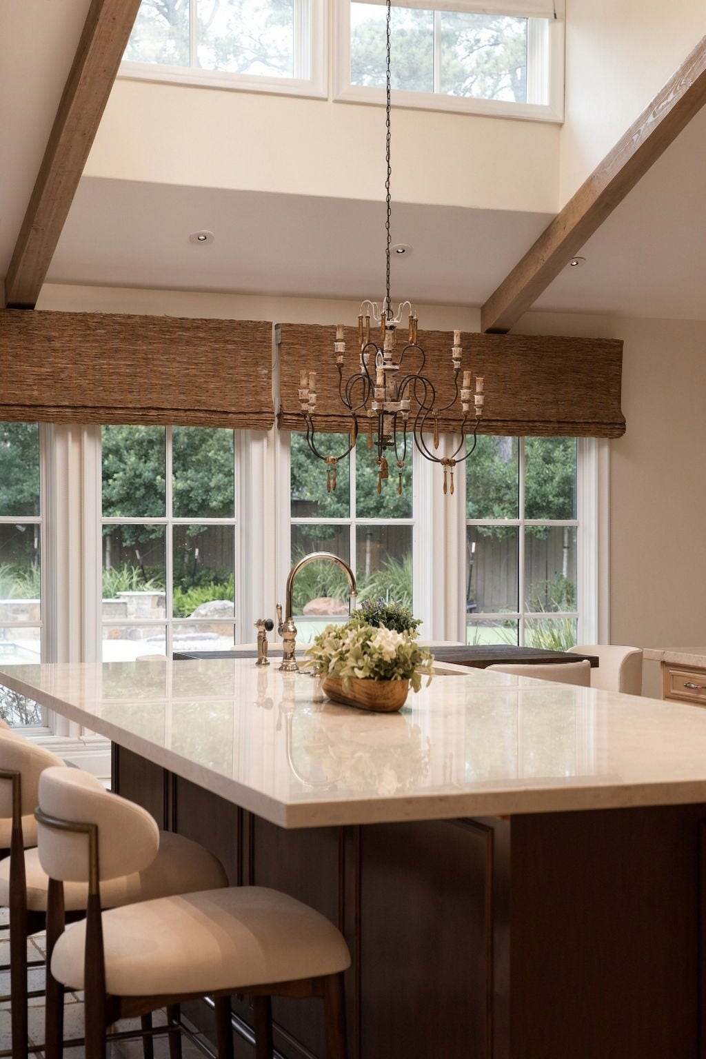 1 Gage Court, Houston, TX 77024 Natural light pours across the kitchen workspace, highlighting the new Taj Mahal countertops and substantial island. The rooms scale allows for generous prep space, seating and direct access to the main living areas.