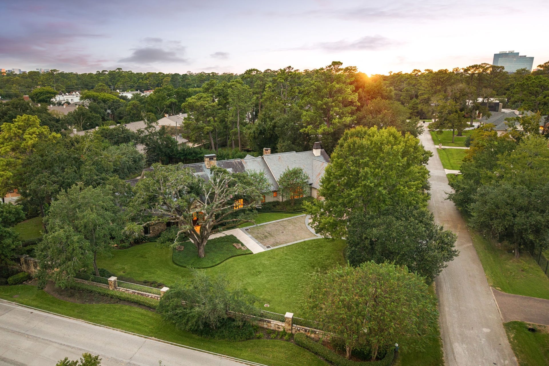 1 Gage Court, Houston, TX 77024 An aerial view captures the scale of the fully gated 37,824-square-foot estate, including the residence, pool, pavilion and landscaped grounds. Mature trees create privacy while the propertys nearly acre-sized setting remains exceptionally close to the heart of Memorial.