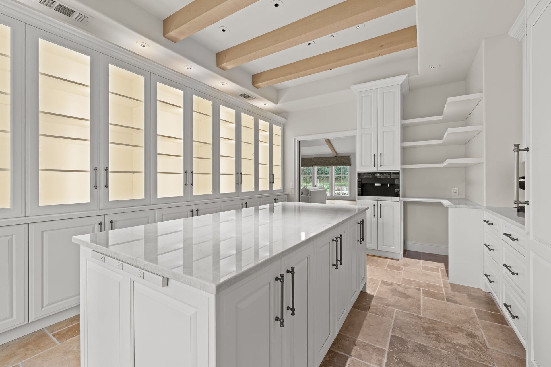 1 Gage Court, Houston, TX 77024 The butlers pantry continues with extensive glass-front cabinetry and integrated Thermador refrigeration and wine storage. The amount of concealed and display storage makes this one of the homes most functional supporting spaces.