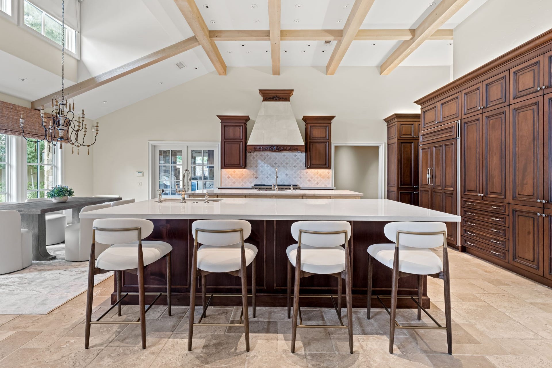 1 Gage Court, Houston, TX 77024 The kitchen is centered around a substantial island with brand-new Taj Mahal countertops and generous seating. Custom cabinetry, exposed ceiling beams and professional-grade appliances give the space both architectural presence and everyday function.