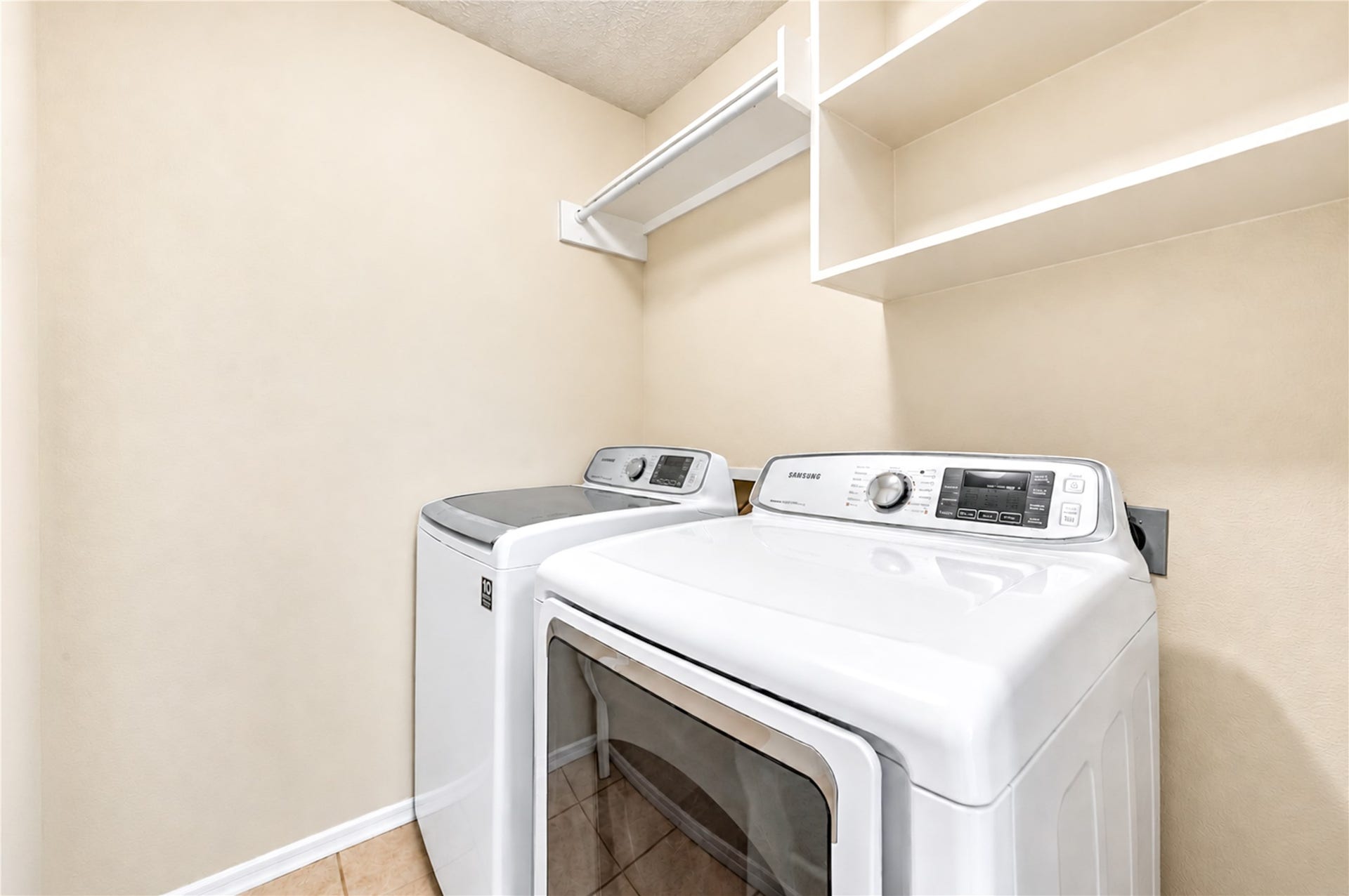 3835 Heritage Colony Drive, Missouri City, TX 77459 Laundry room w/ shelving, washer and dryer stay