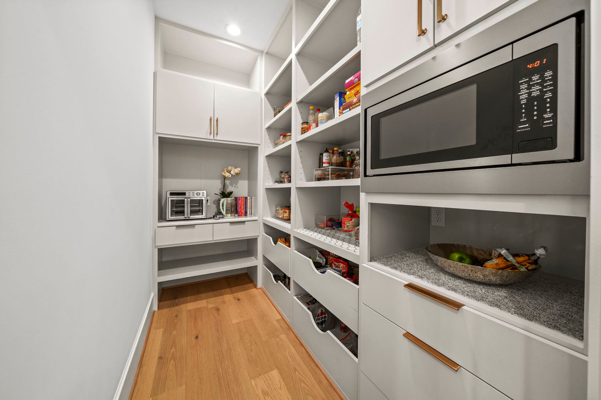 6425 Remlap Street, Houston, TX 77055 This pantry is amazing! The microwave is hidden in this room and custom built ins provide a great way to stay organized!