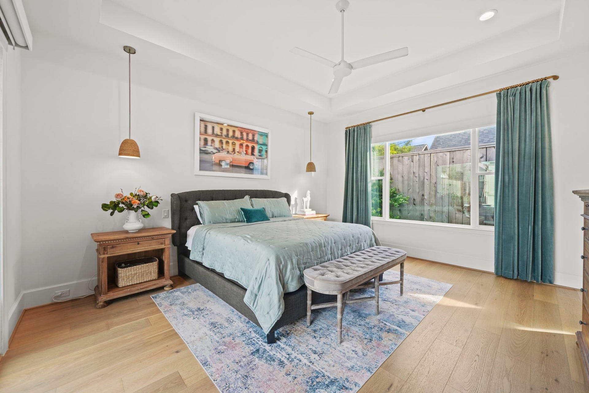 6425 Remlap Street, Houston, TX 77055 The primary bedroom has the same gorgeous wood flooring that is throughout the rest of the home and custom pendant lighting!