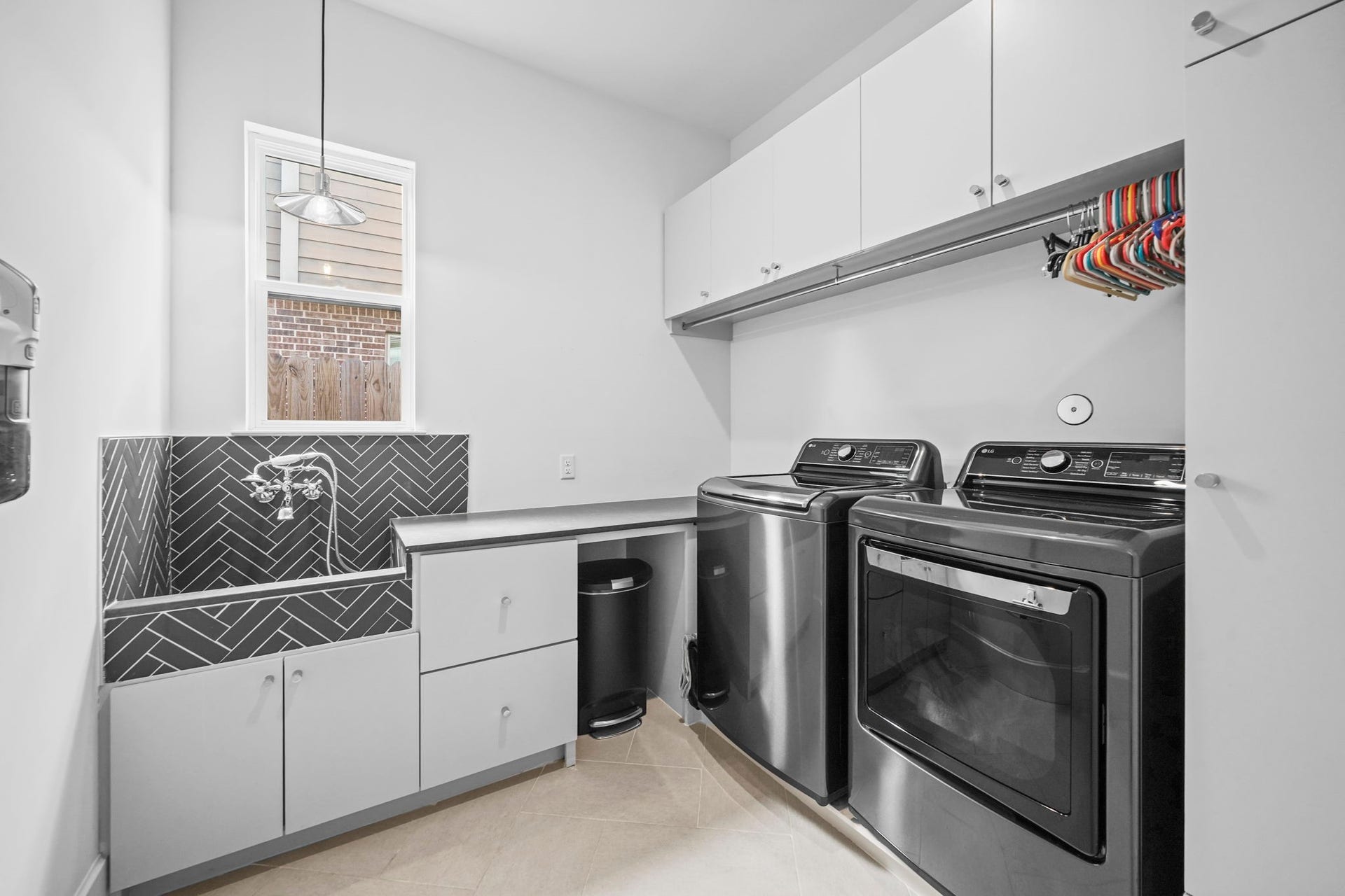 6425 Remlap Street, Houston, TX 77055 The amazing laundry room has a dog wash station and the washer and dryer convey with the home!