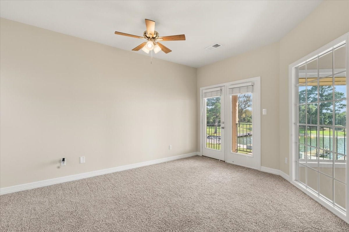 3326 Desert Inn Drive, Montgomery, TX 77356 Upstairs bedroom with french doors leading to private covered patio overlooking the lake