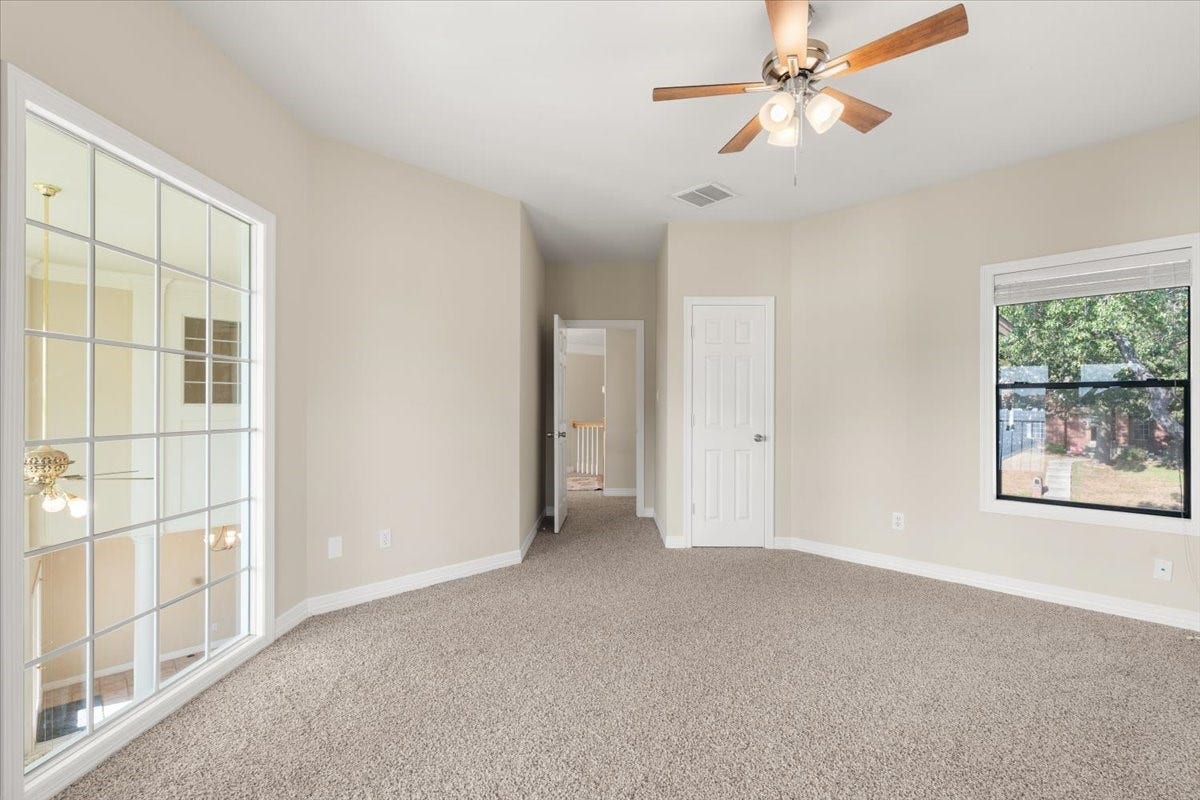 3326 Desert Inn Drive, Montgomery, TX 77356 Upstairs bedroom with french doors leading to covered deck. Take in the views from the top floor. Walk in closet with built ins and ceiling fan