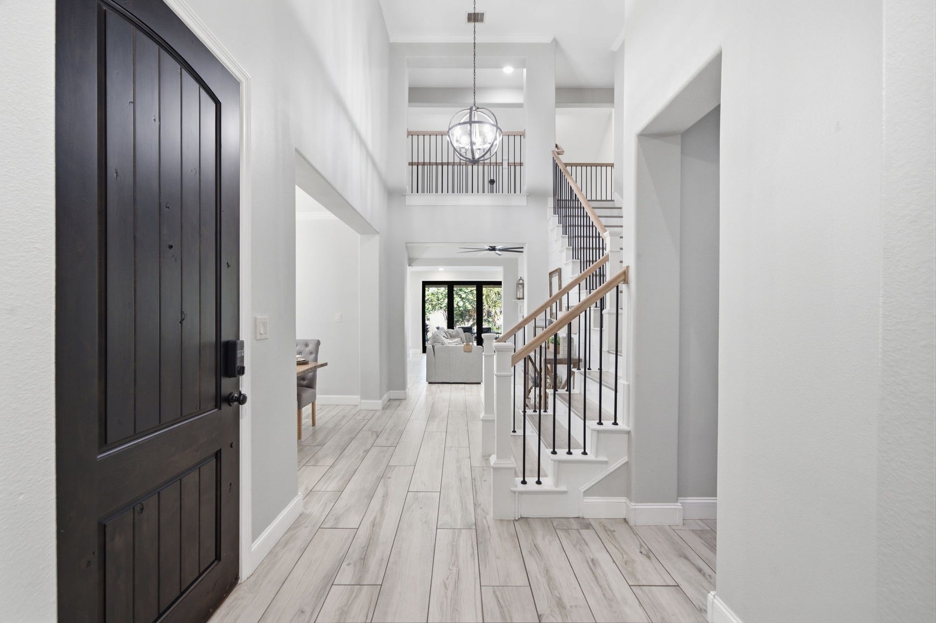 28449 Ofallon Mills Drive, Spring, TX 77386 Step into elegance with this stunning foyer, featuring high ceilings and a graceful staircase that sets the tone for the rest of the home.