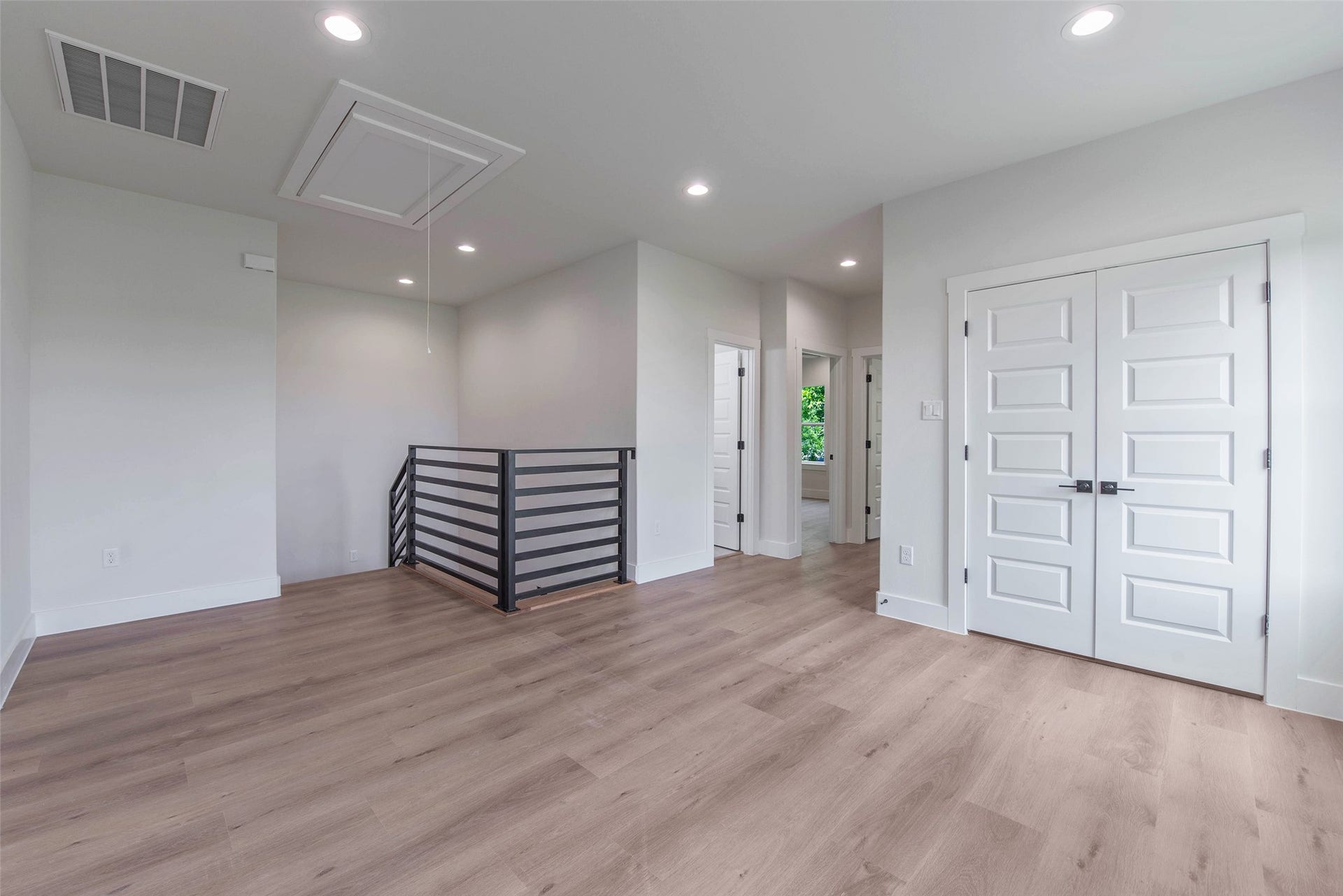 The doors open to two well-appointed secondary bedrooms and the secondary bath.