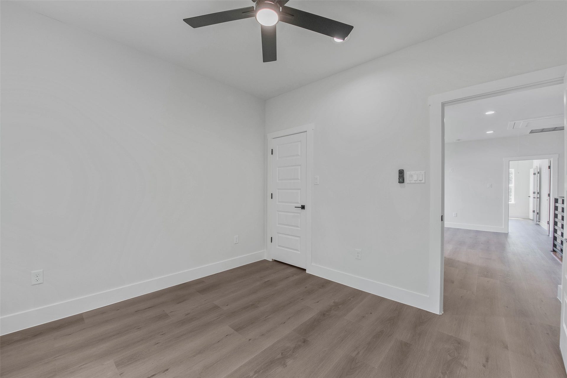 One of two secondary bedrooms, featuring a closet, no carpet, and a clean, modern finish.