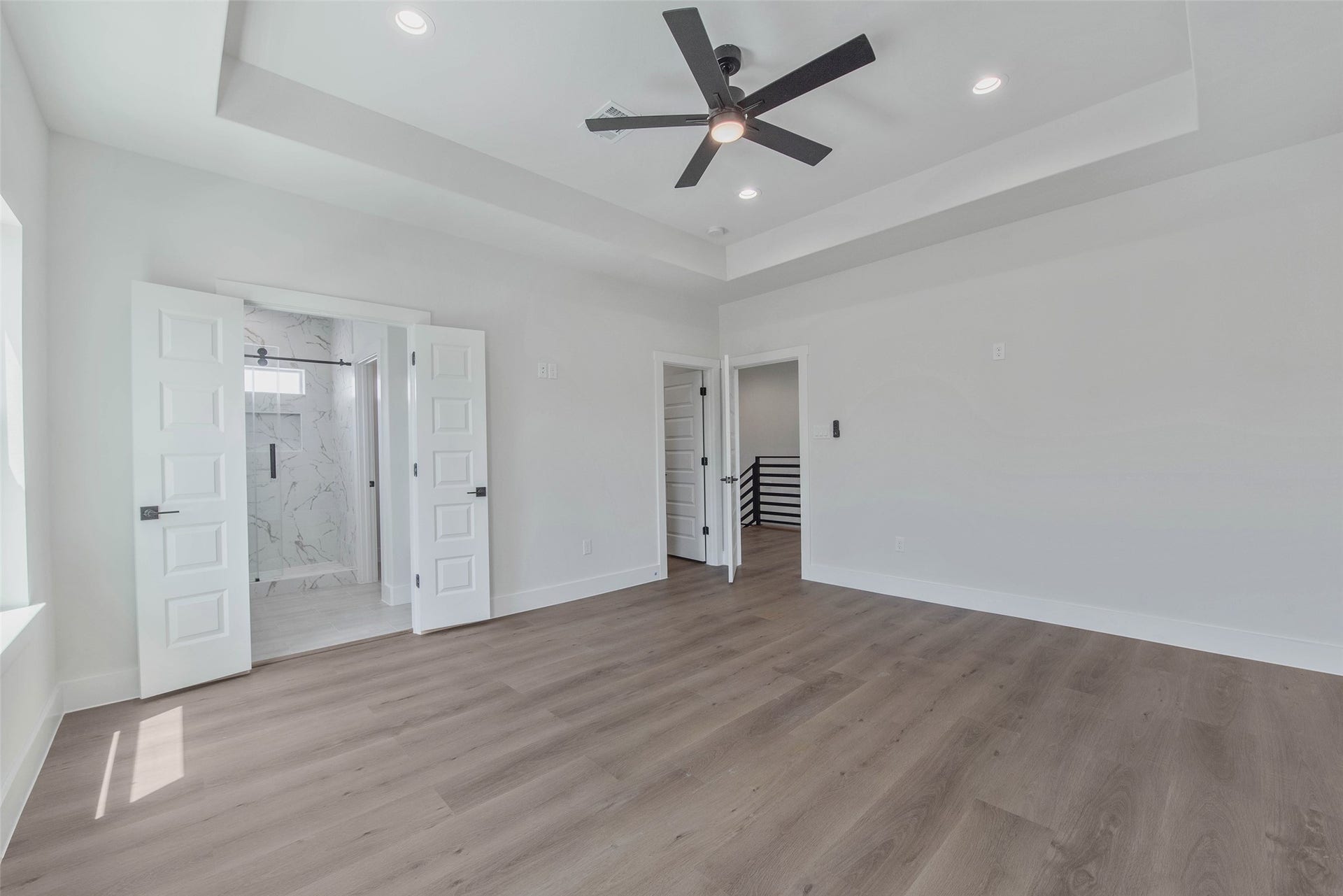A large, light-filled bedroom offers a bright and comfortable retreat.