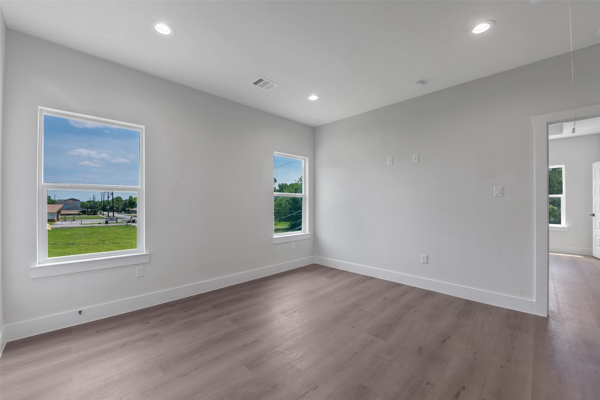 Another angle of the flexible upstairs space, showcasing its open feel and the convenient doorway leading directly to the primary suite.