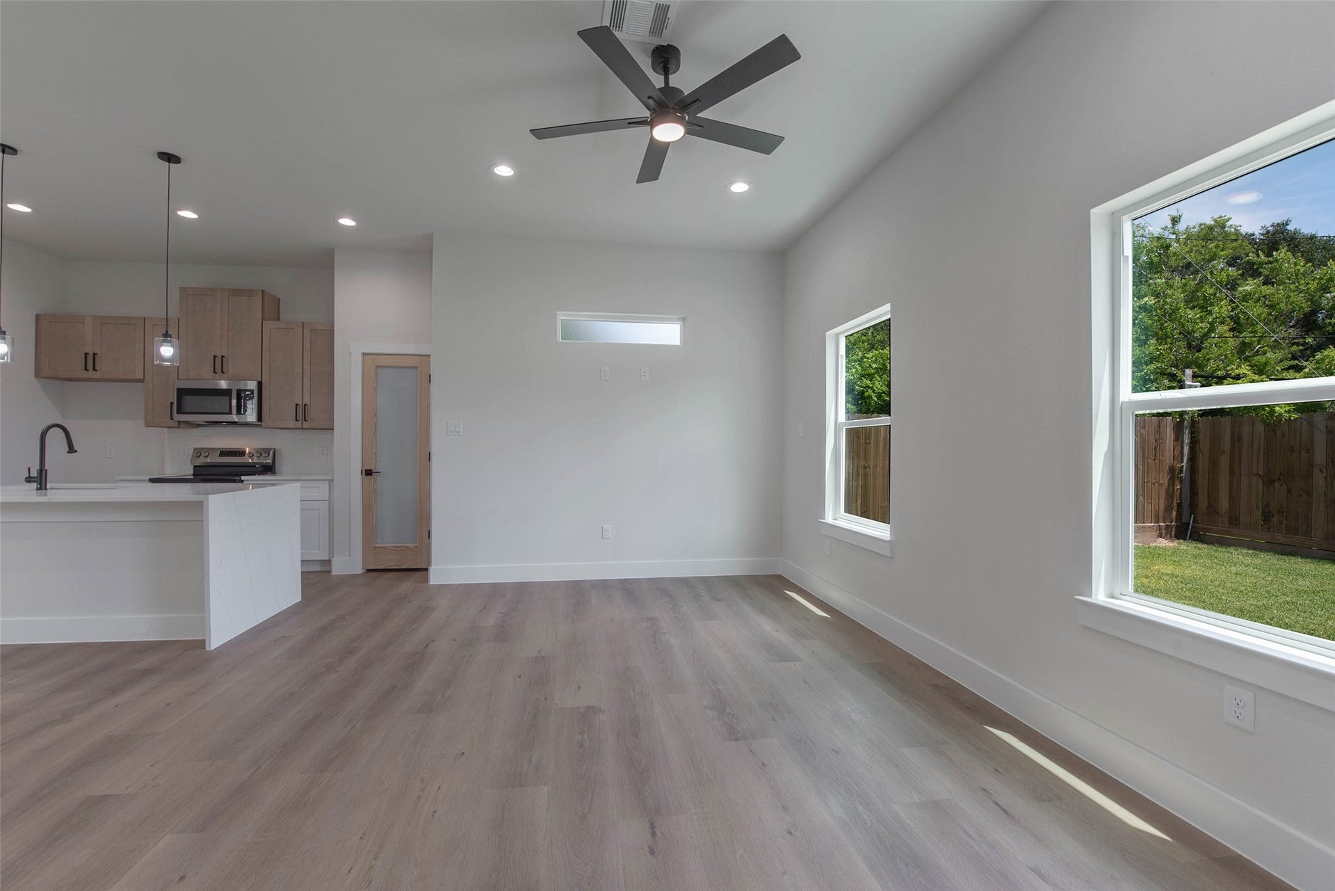 Expansive windows fill the home with natural light, while the no-carpet design and lovely fixtures add a clean, elevated feel throughout.