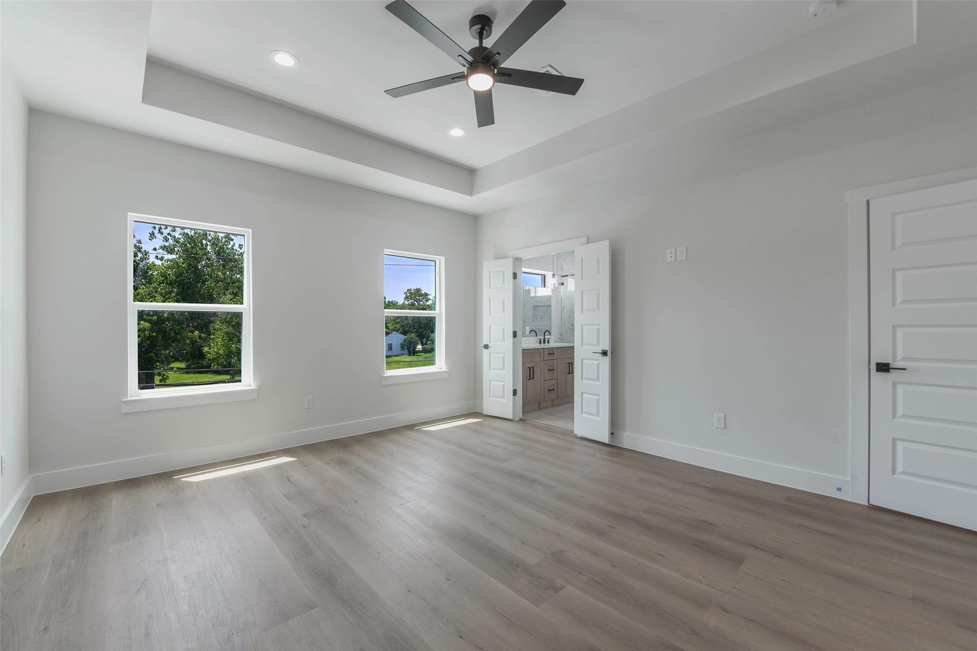 The upper level features a private primary bedroom with an ensuite bath and spacious walk-in closet.
