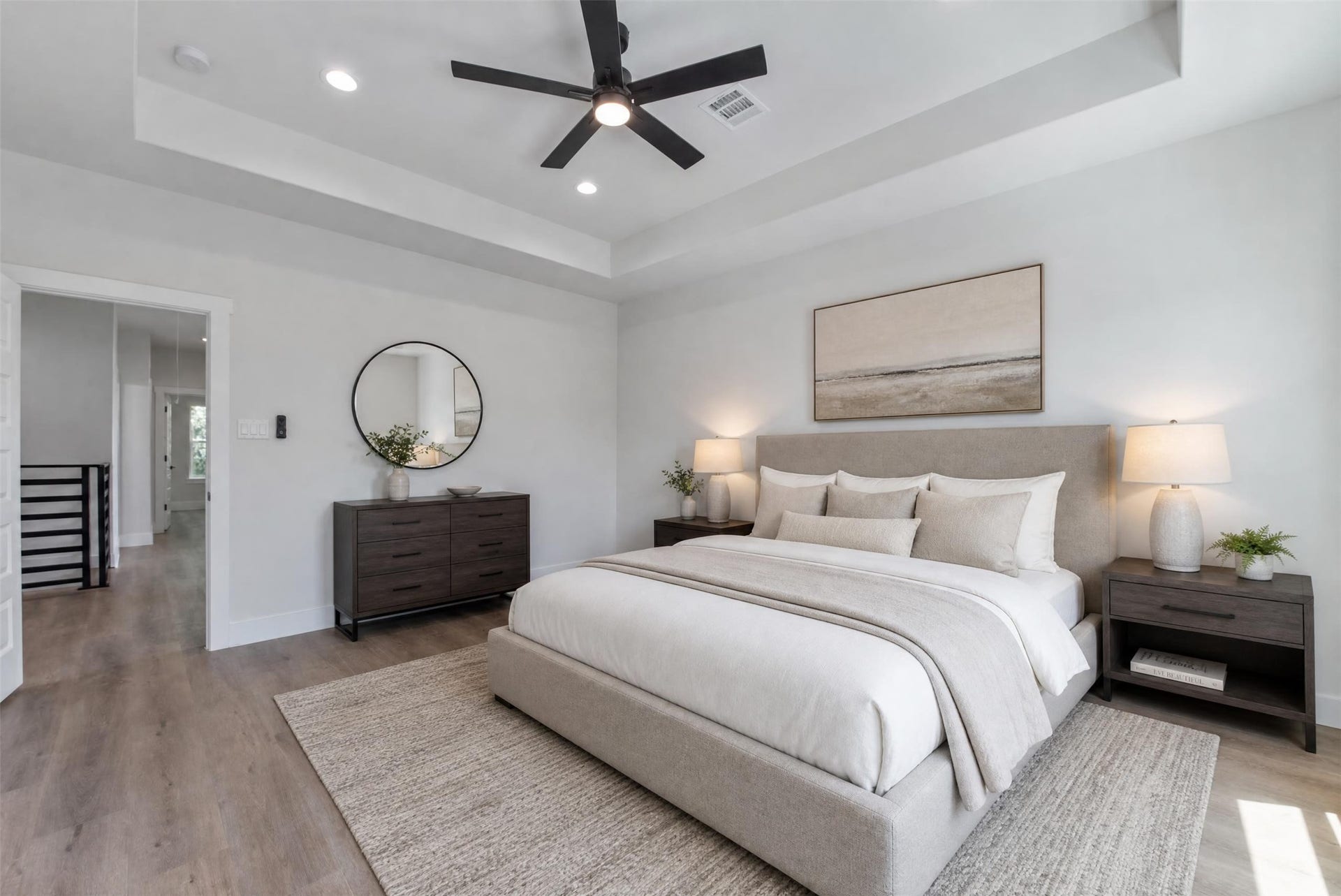 The spacious primary bedroom is privately situated just off the versatile flex space, offering a peaceful retreat with abundant natural light through large windows and an elegant recessed ceiling. The adjoining ensuite bath provides added comfort and convenience, creating a well-appointed primary suite designed for relaxation.