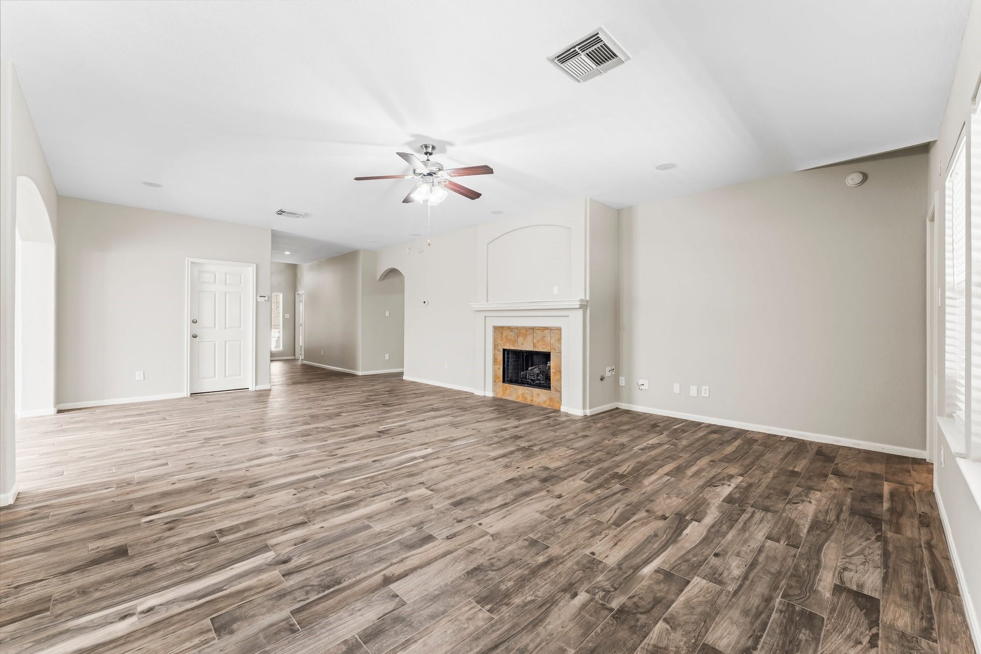 34 Bryce Branch Circle, The Woodlands, TX 77382 In addition to the fireplace, this elegant Family room features wood-look ceramic tile flooring, fresh paint, lighted ceiling fan, and surround sound ceiling speakers.