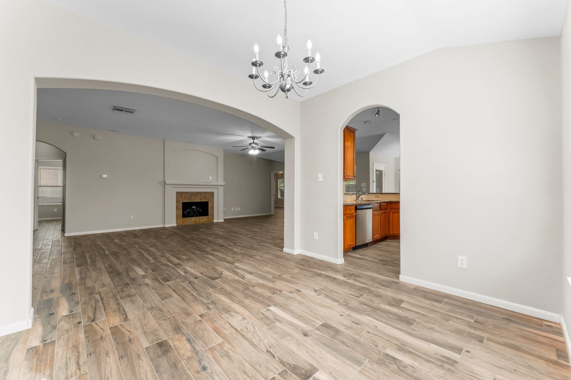34 Bryce Branch Circle, The Woodlands, TX 77382 Another view of the Dining Room looking into the Kitchen and main living area. The open floor plan allows for easy flow throughout home, and the arched entryways lend a touch of class and elegance!