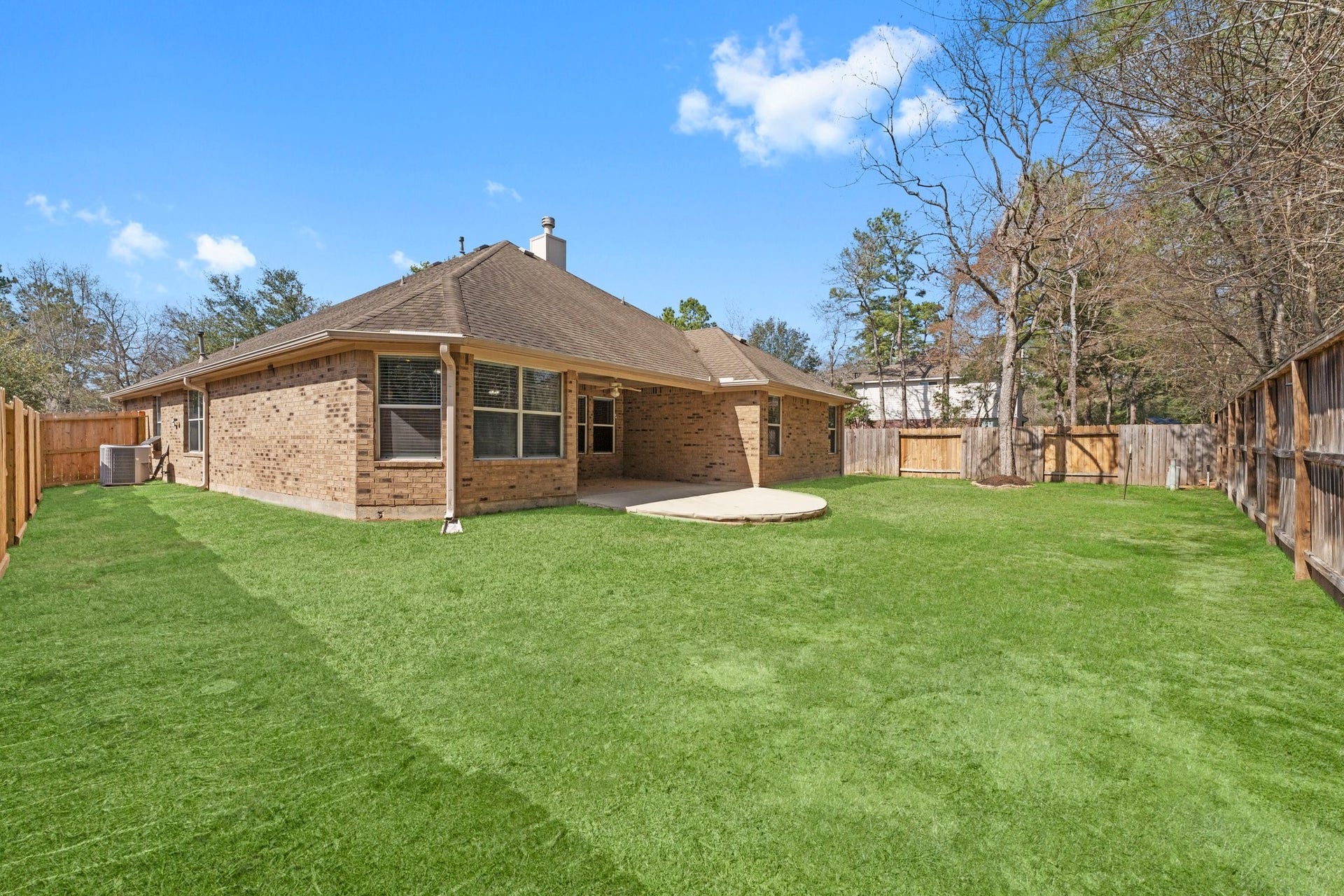 34 Bryce Branch Circle, The Woodlands, TX 77382 Home has front and back gutters for easy rainwater management. Plenty of grass for playing or relaxing!