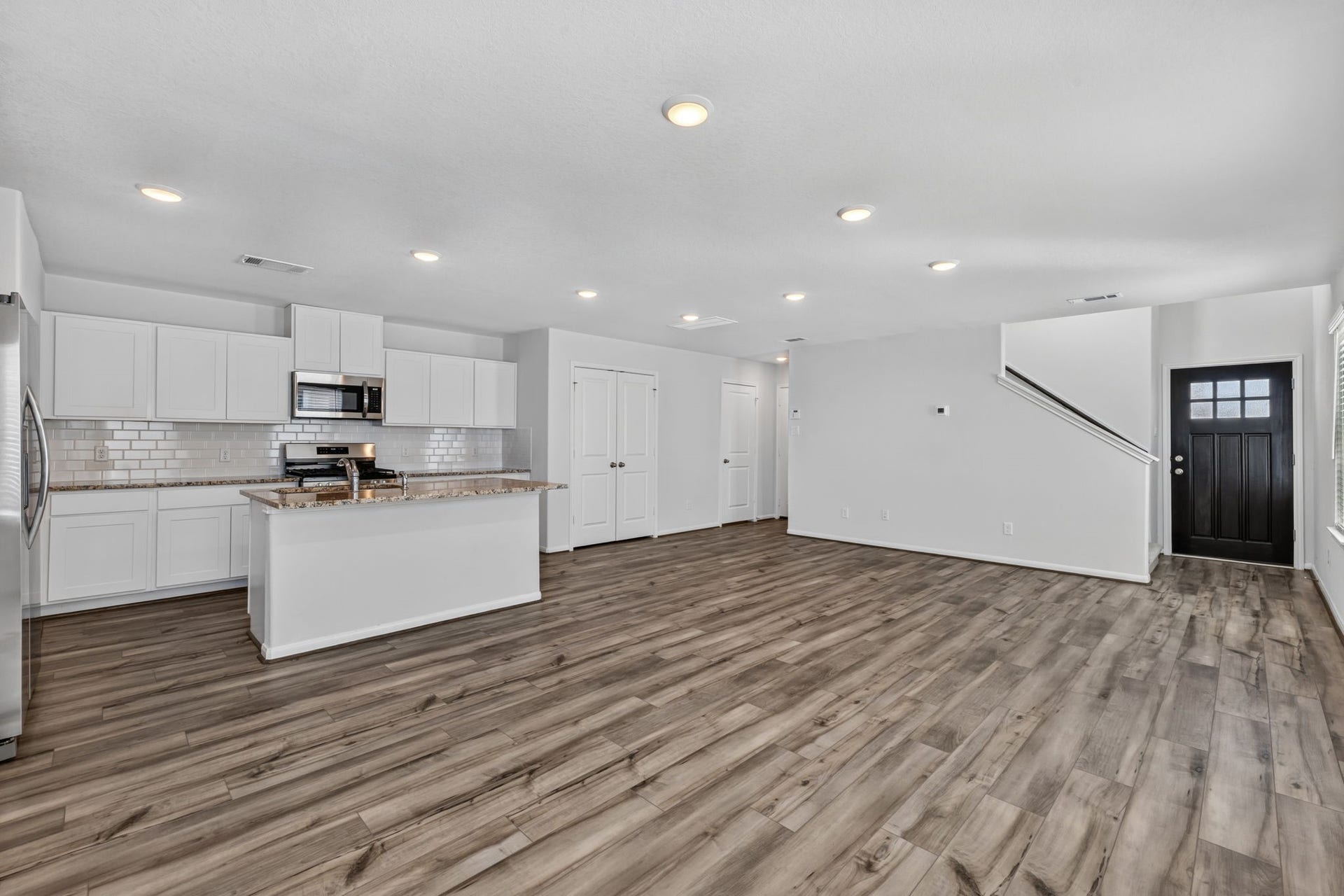 5243 Shallowhurst Lane, Katy, TX 77449 Open concept first floor flows from the front entry into the living and kitchen area with recessed lighting throughout.