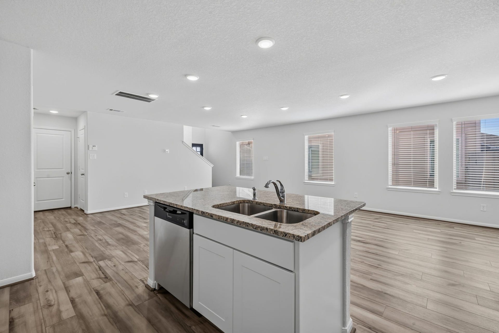 5243 Shallowhurst Lane, Katy, TX 77449 KITCHEN II - The center island has an undermount double sink and dishwasher, and it overlooks the bright living area with its row of windows.