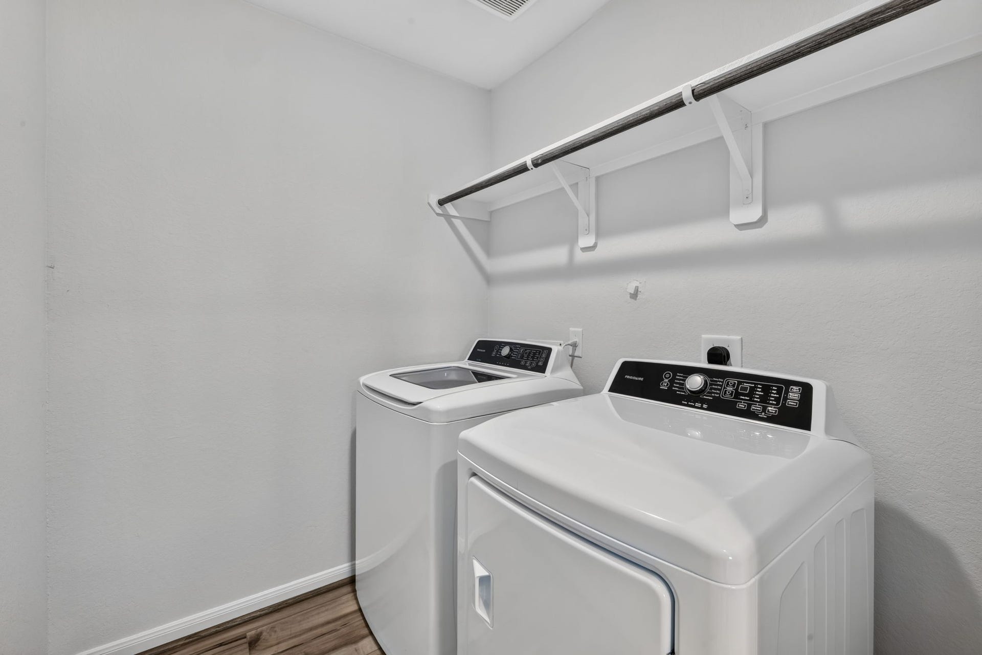 5243 Shallowhurst Lane, Katy, TX 77449 LAUNDRY ROOM - A dedicated laundry room with a hanging rod and shelf, room for a full-size washer and dryer located near the primary bedroom.