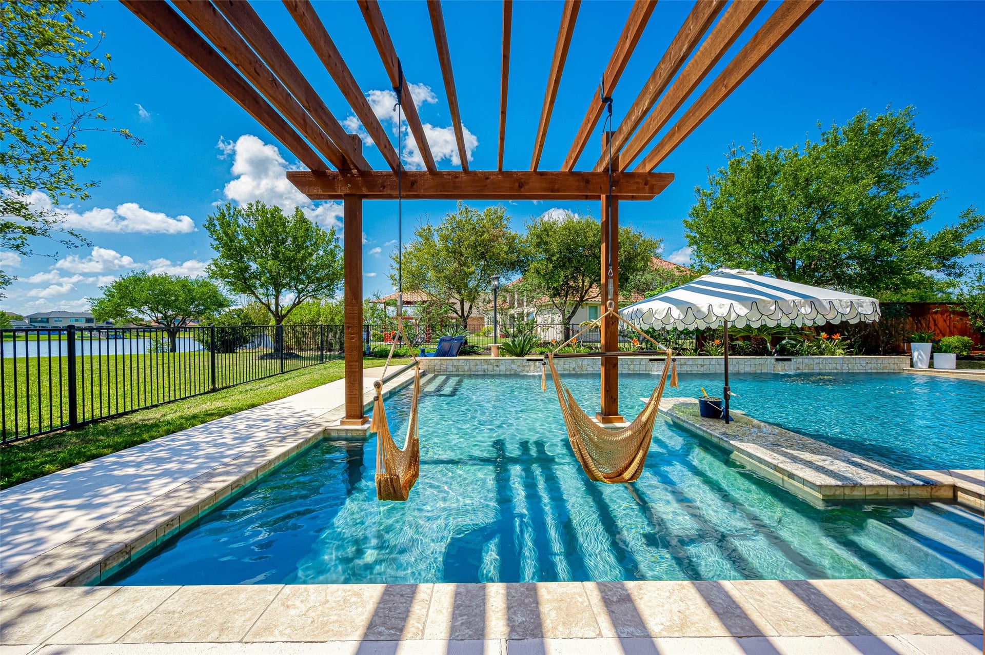 10227 Grape Creek Grove Lane, Cypress, TX 77433 Lakefront paradise with hammocks, pool, and stunning viewseverything you need for ultimate relaxation!