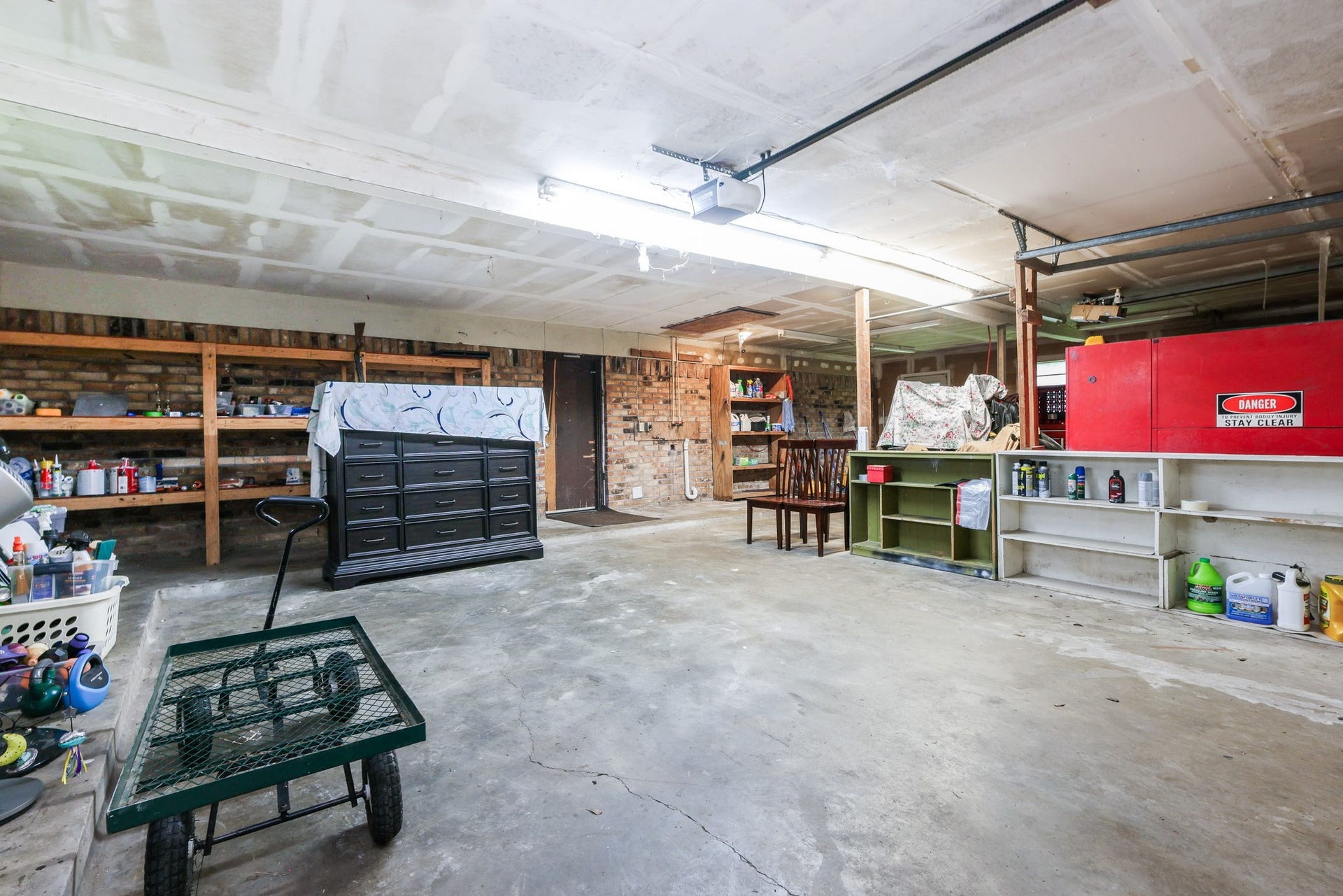 12614 C Bar Drive, Santa Fe, TX 77510 Oversized Garage with built-in heavy duty shelving, door to backyard and washer/dryer connections
