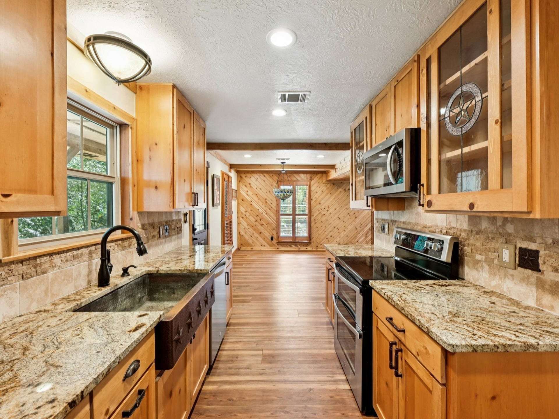 101-1/2 Avenue J, Dickinson, TX 77539 The copper farmhouse sink and custom wood cabinetry, with some glass doors, add to the charm of this Kitchen.
