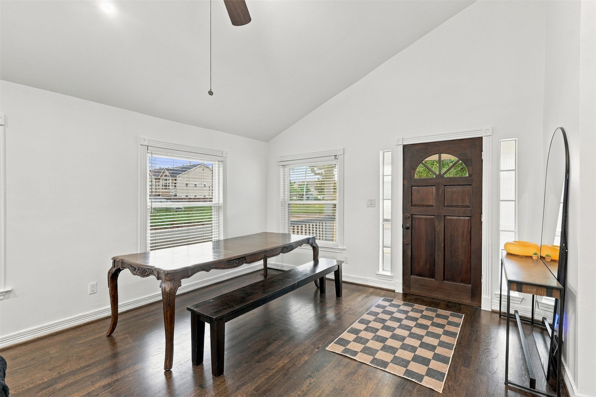 5410 Kiam Street, Houston, TX 77007 Bright entryway with high ceilings, showcasing a classic wooden door and expansive windows that fill the space with natural light.