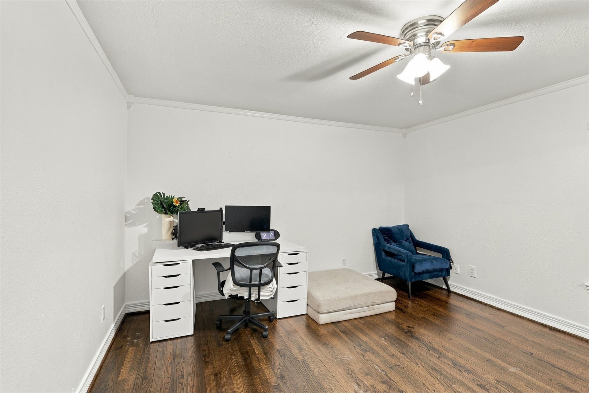5410 Kiam Street, Houston, TX 77007 Bright and spacious home office with elegant hardwood floors, featuring a modern desk setup and a comfortable seating area under a ceiling fan.