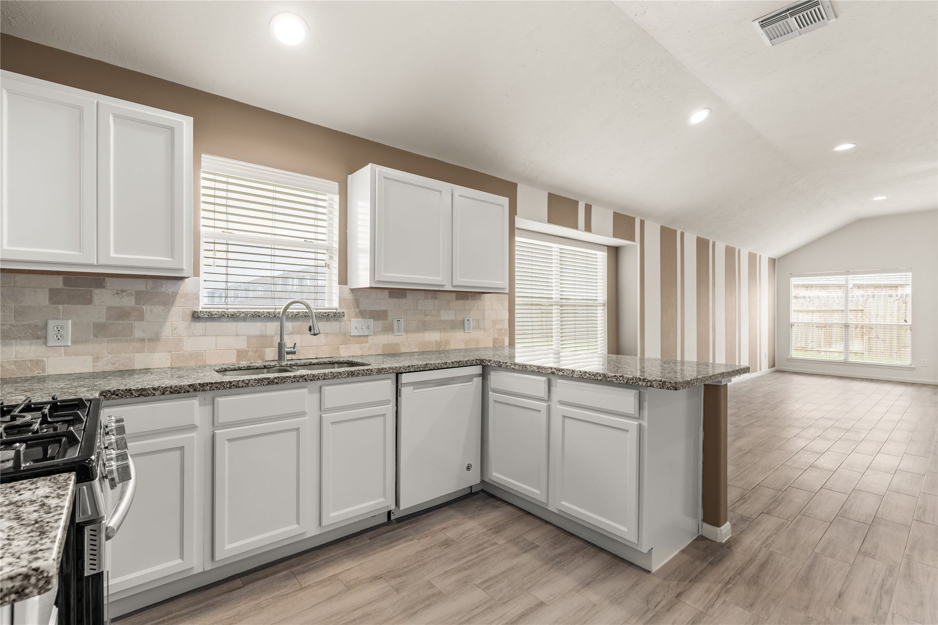 17042 Midnight Sun Lane, Richmond, TX 77407 The open-concept design seamlessly connects the kitchen and living room, creating an ideal space for everyday living and entertaining.
