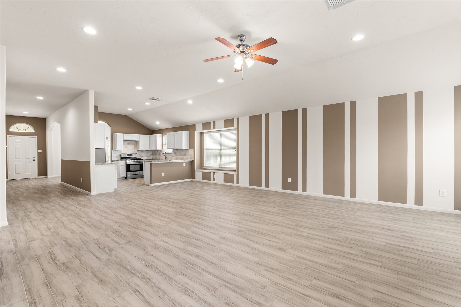 17042 Midnight Sun Lane, Richmond, TX 77407 The eye-catching accent wall creates a stylish focal point while complementing the home's open-concept design.